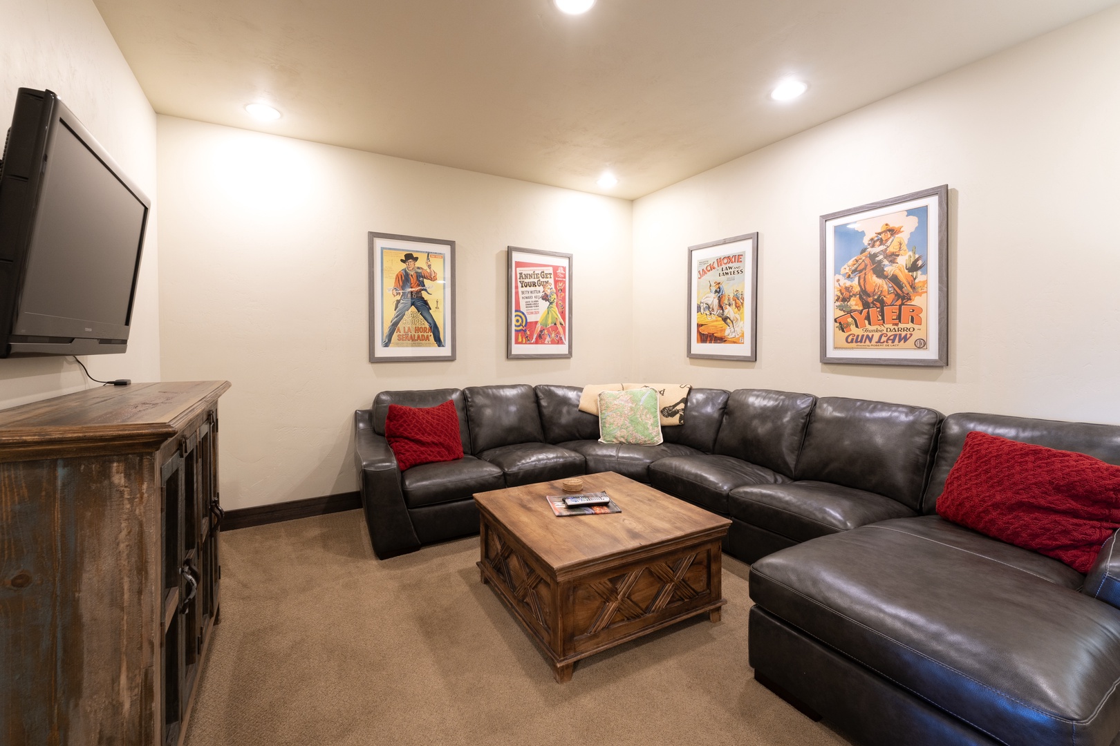 Kick back in this cozy lounge with a plush sectional and vintage Western movie posters—perfect for your movie nights in.