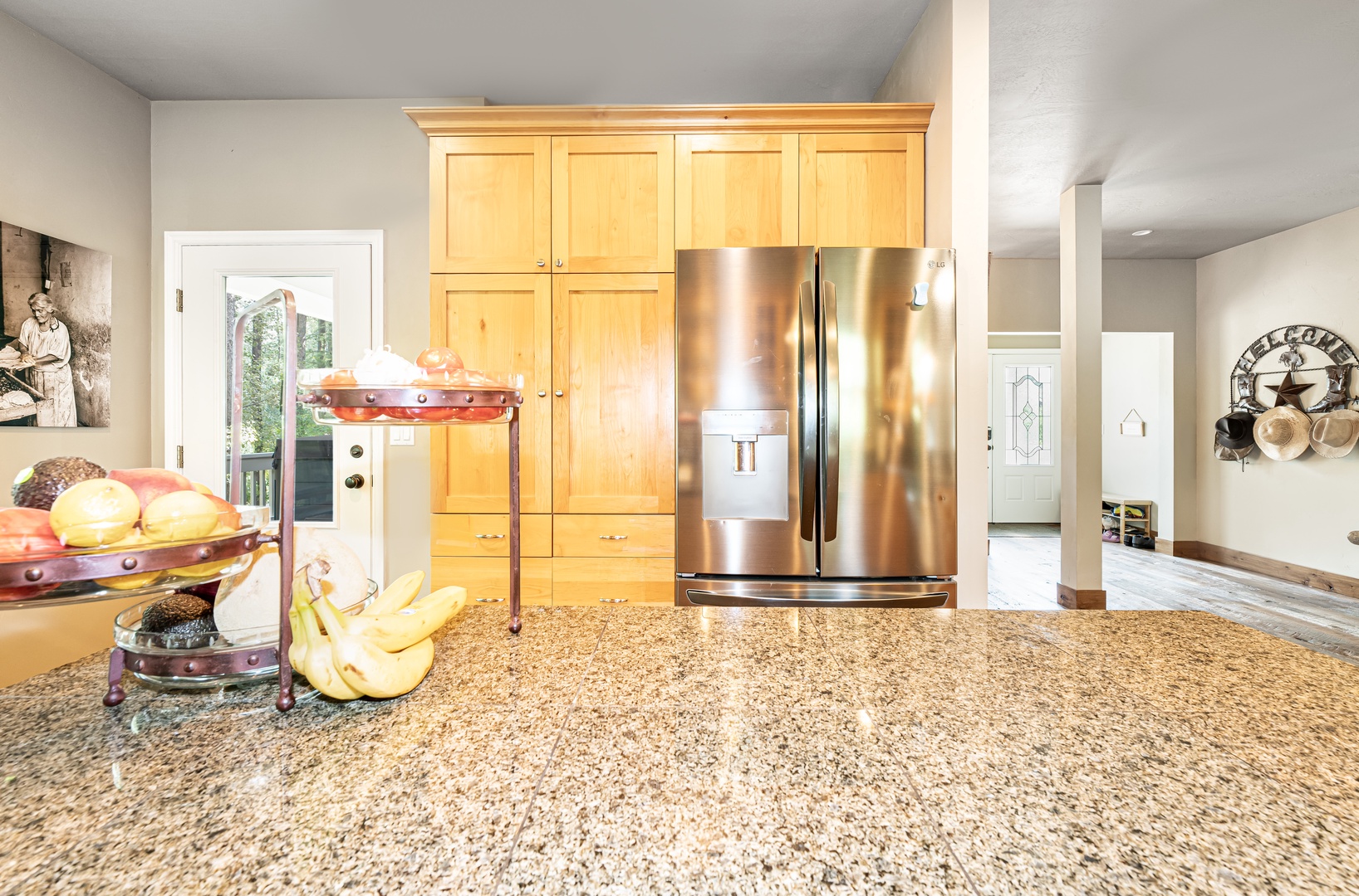Your fully equipped kitchen sparkles with granite countertops and stainless steel appliances, ready for preparing meals or gathering with friends over morning coffee.