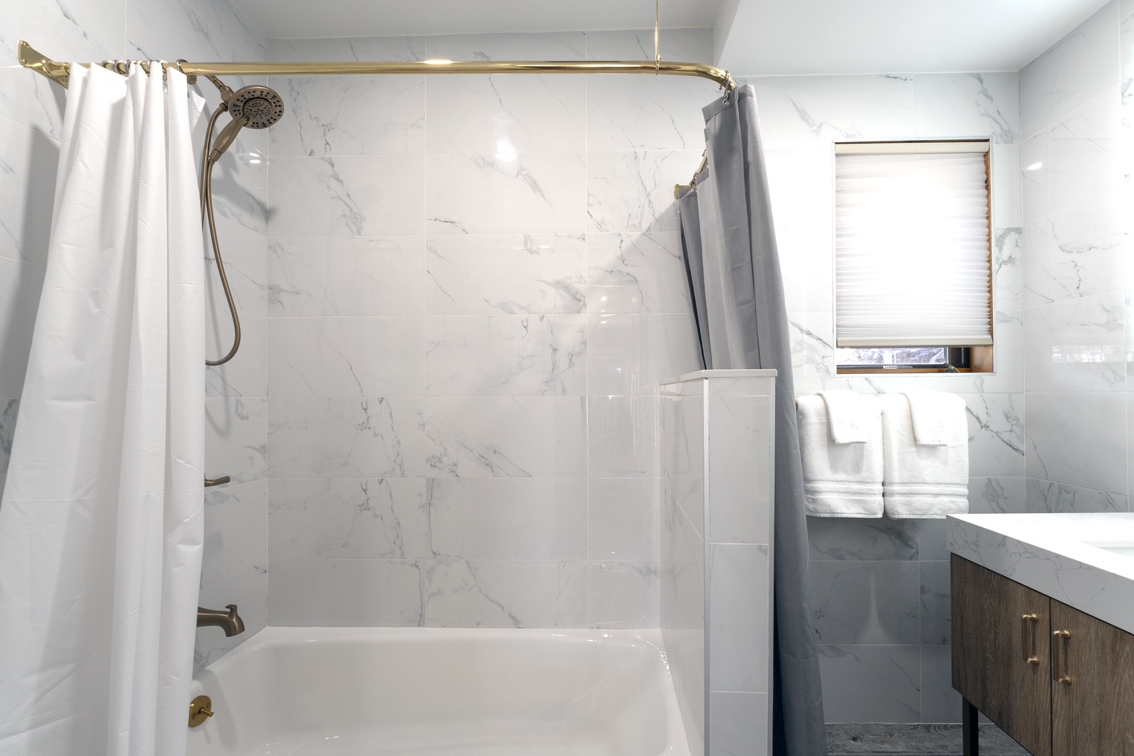 Refresh in your private marble-tiled bathroom with a tub-shower combo and plush towels waiting for you after a day of exploring.
