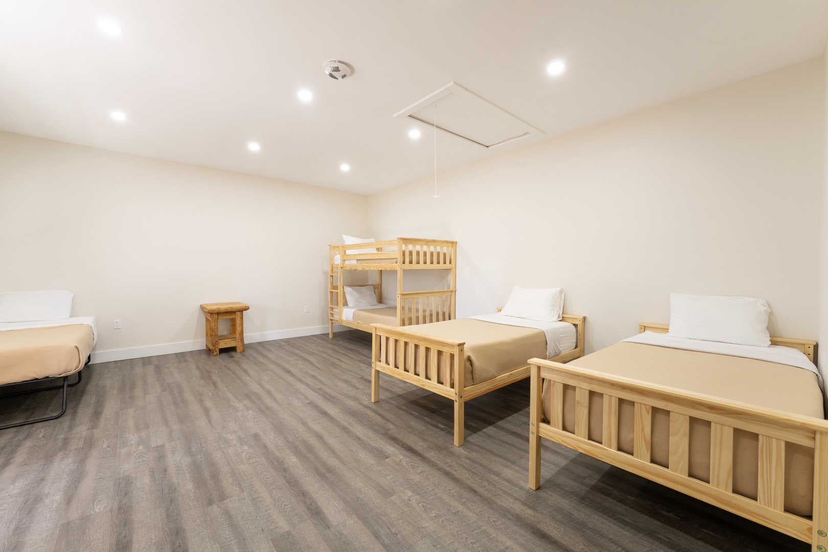 Your spacious room features warm wood furnishings with three twin beds and a bunk bed, perfect for families or groups traveling together.