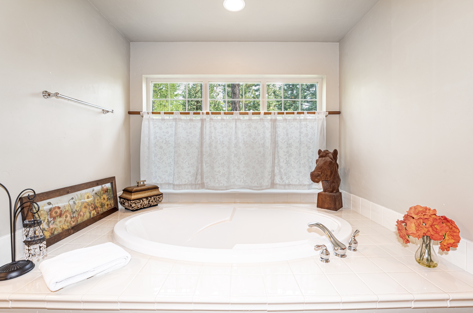 Soak away stress in your private garden tub, where natural light filters through the window and thoughtful touches create a peaceful retreat.