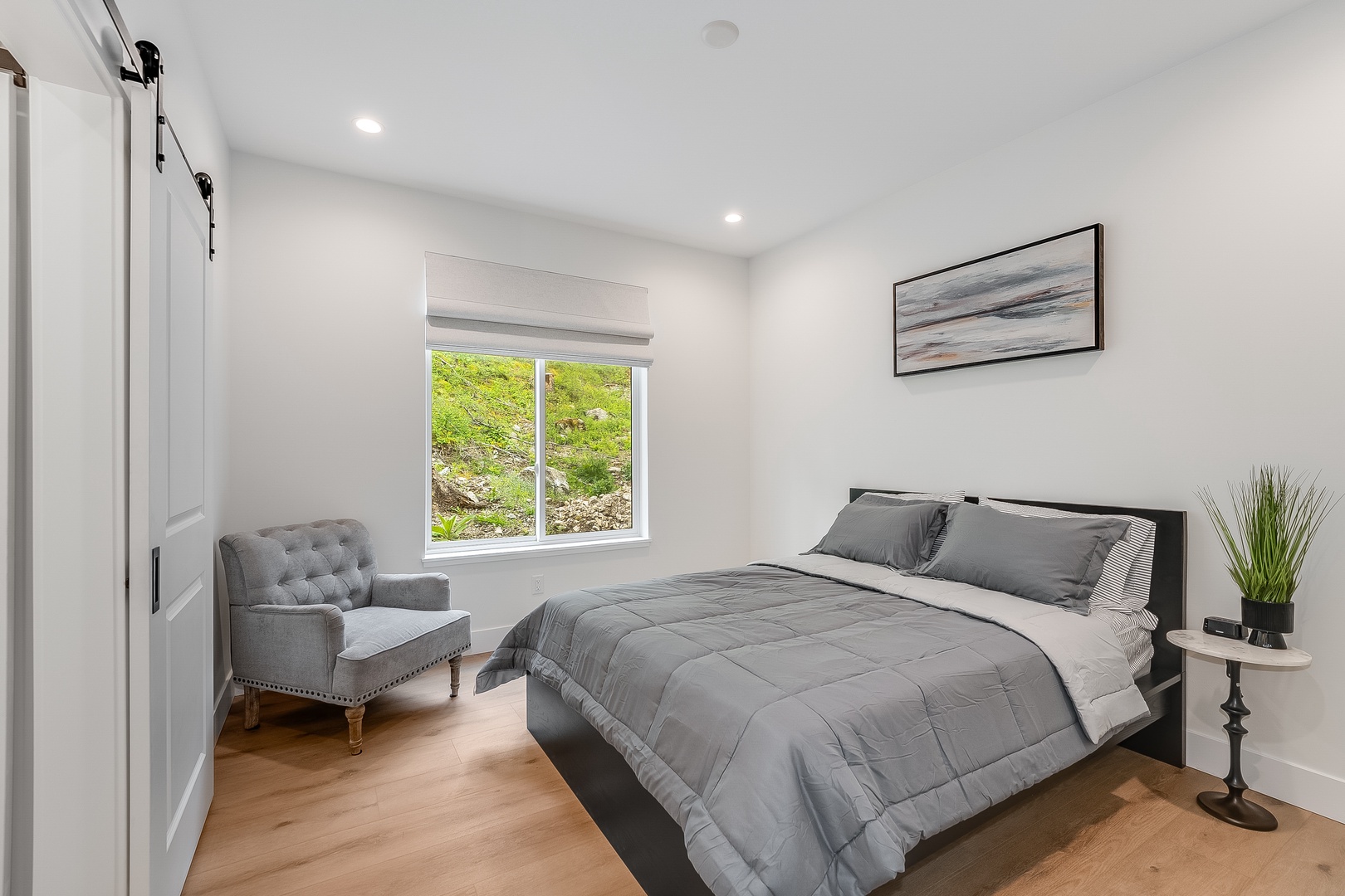Settle into crisp linens and a serene space designed for restful nights. The natural light and cozy furnishings create your perfect retreat.