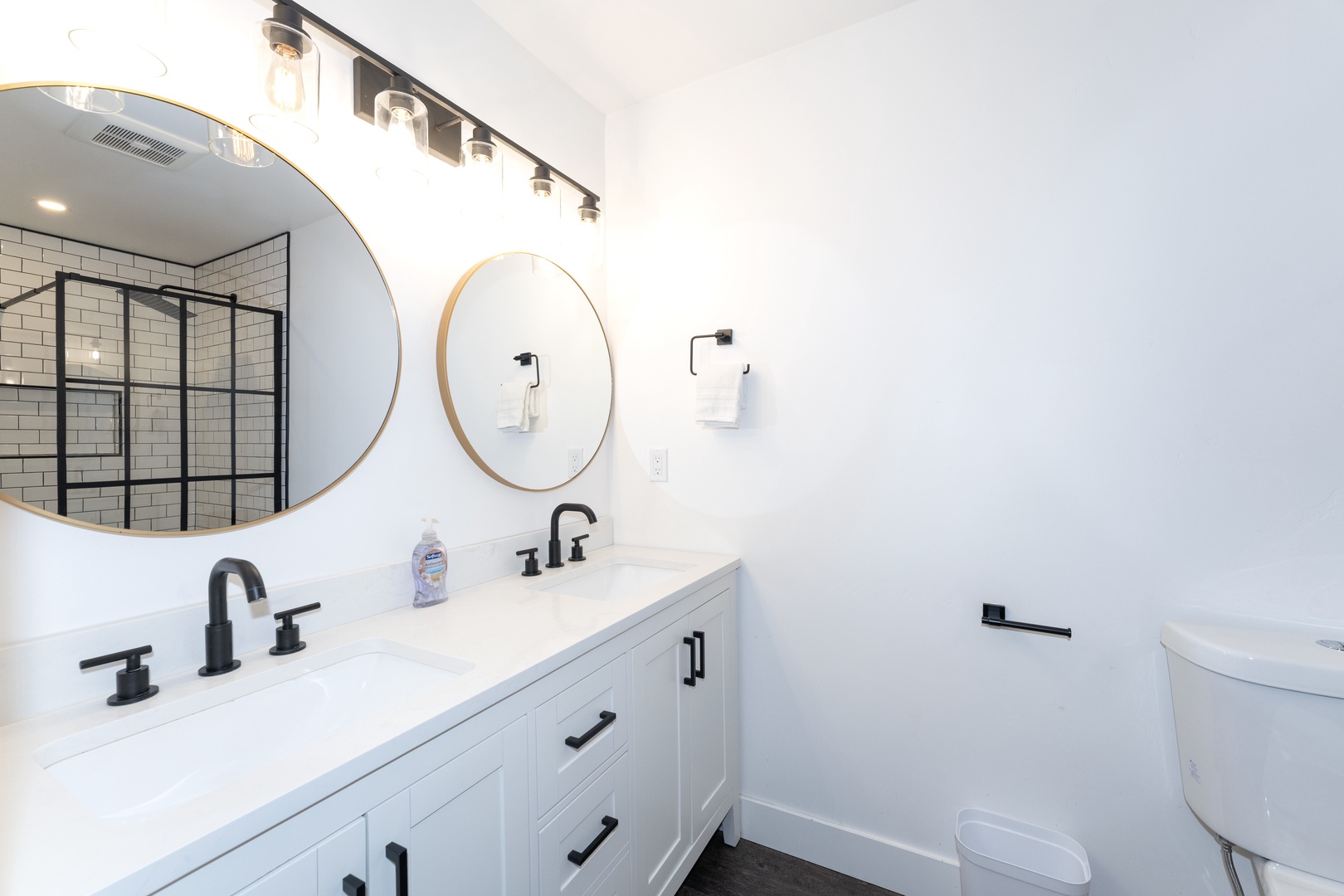 Your sleek bathroom features double vanity, elegant mirrors, and modern fixtures—perfect for refreshing after your daily adventures.