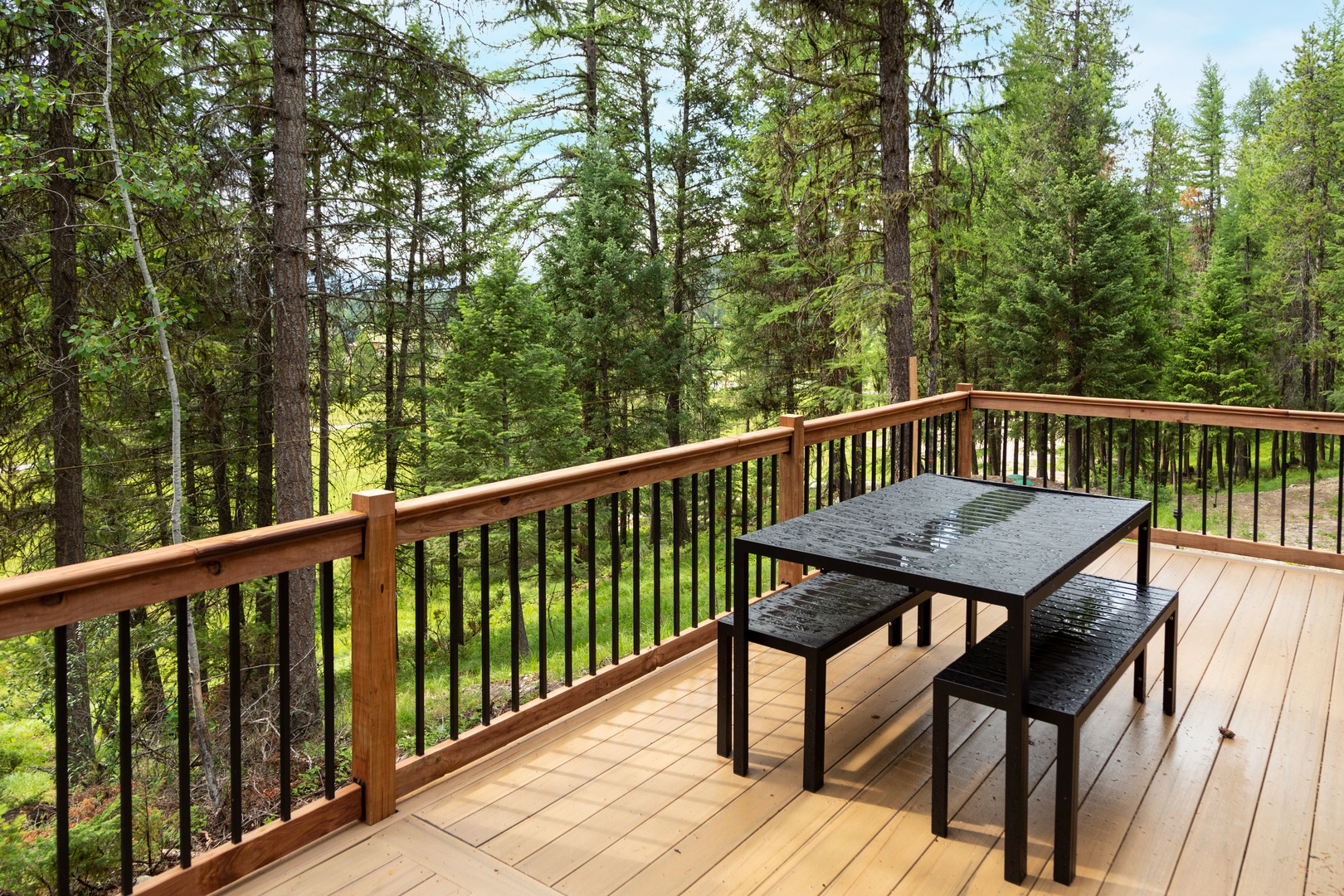 Step outside onto your private deck and enjoy morning coffee or evening meals surrounded by towering pines and peaceful forest views—a serene retreat for unwinding in nature.