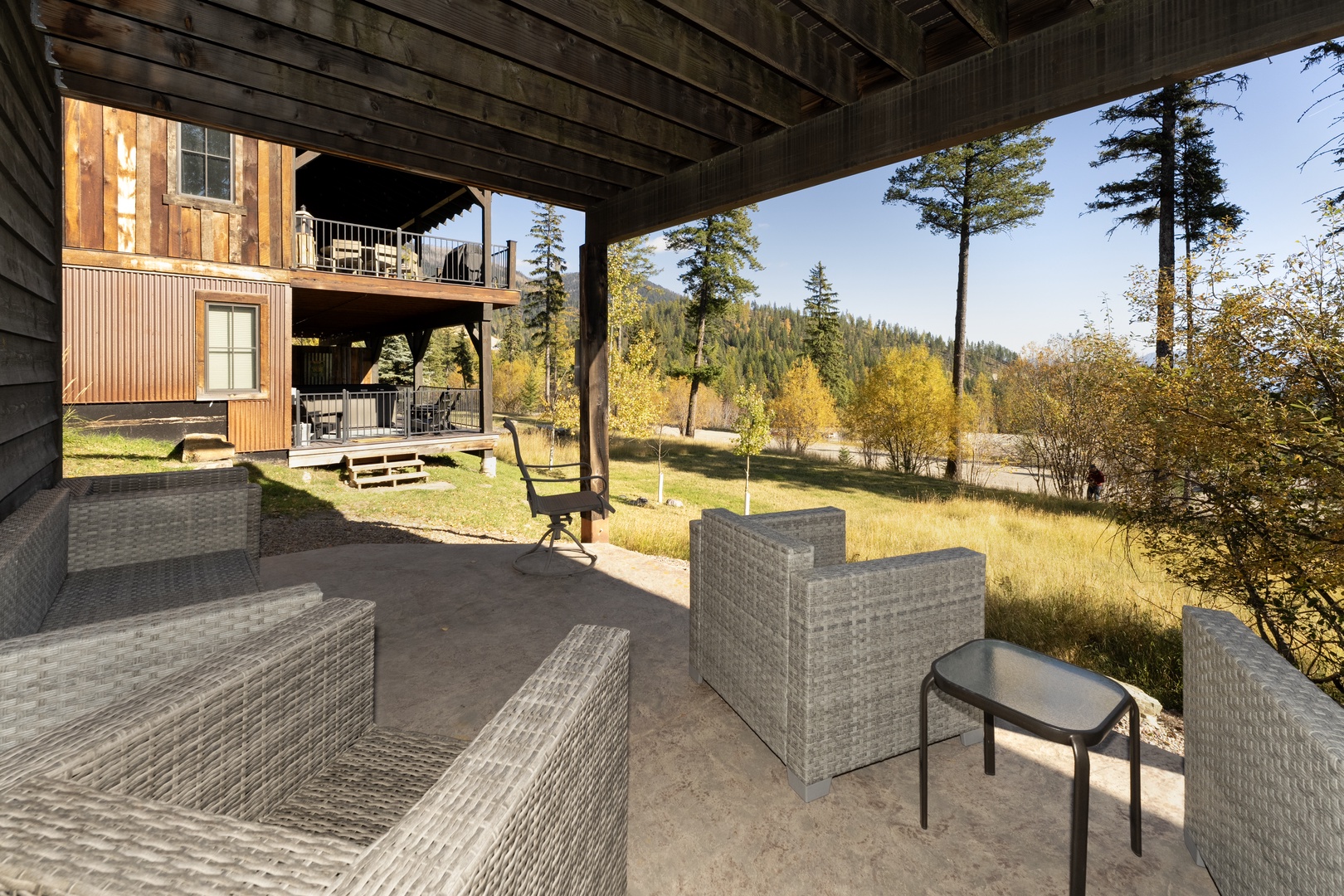 Settle into your private covered patio and soak in the peaceful forest and meadow views stretching toward the distant hills. Your perfect spot for morning coffee or evening relaxation awaits.