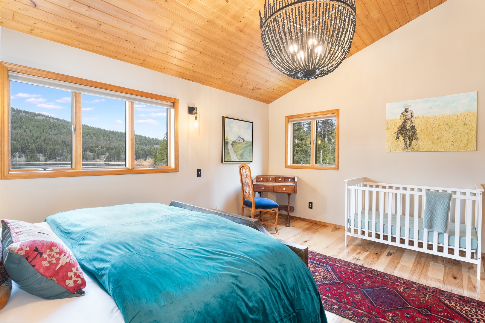 Drift off beneath stunning mountain vistas in your cozy bedroom, where warm wood ceilings and thoughtful touches create perfect family comfort.