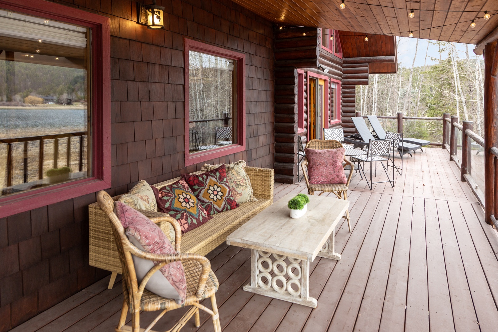 Unwind on your private lakefront deck with cozy wicker seating and stunning water views just beyond the railing.