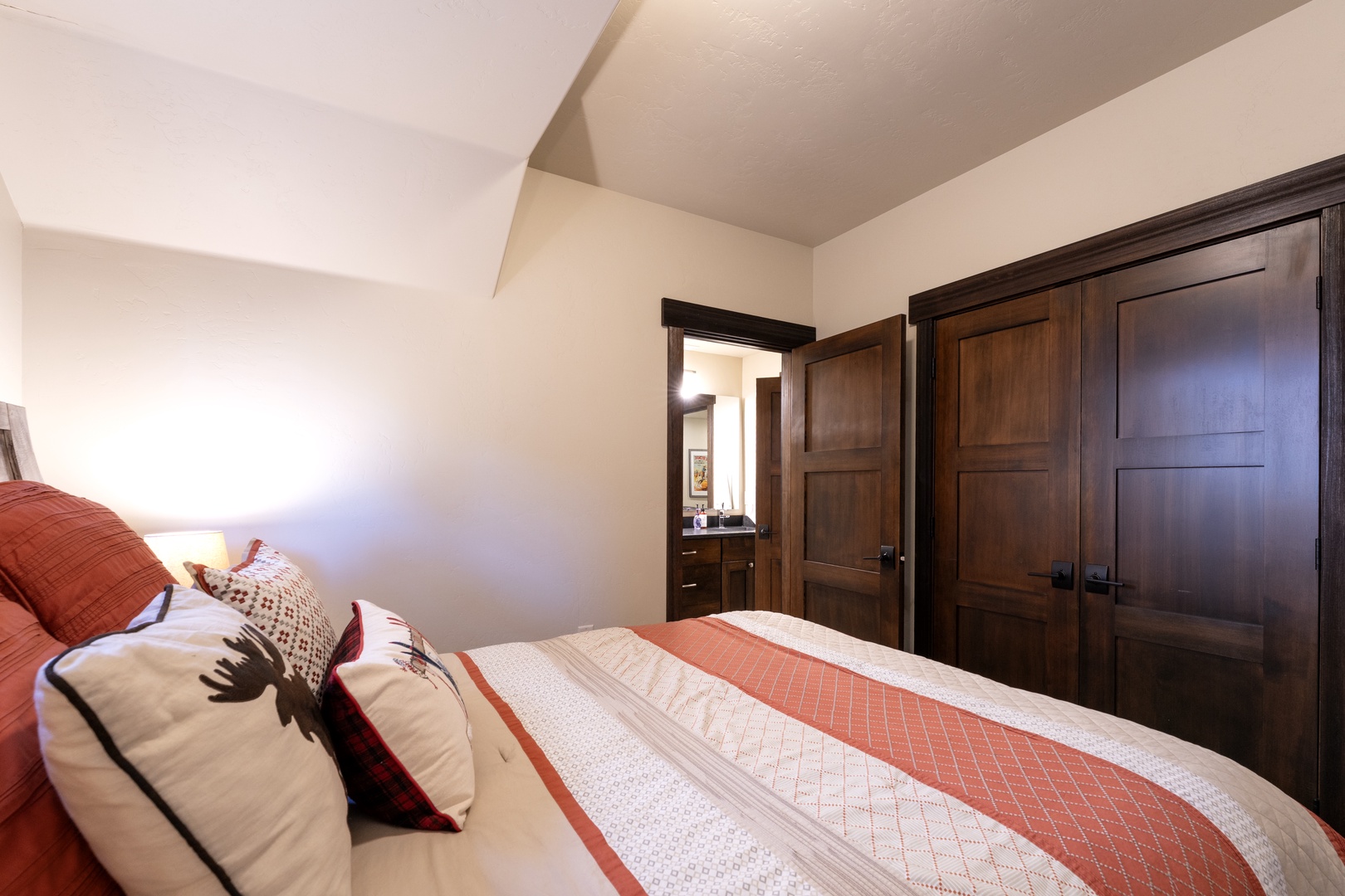 Sink into crisp, inviting linens and let the warmth of rich wood tones and soft textures surround you. Your peaceful retreat awaits, complete with ample closet space and an ensuite just steps away.