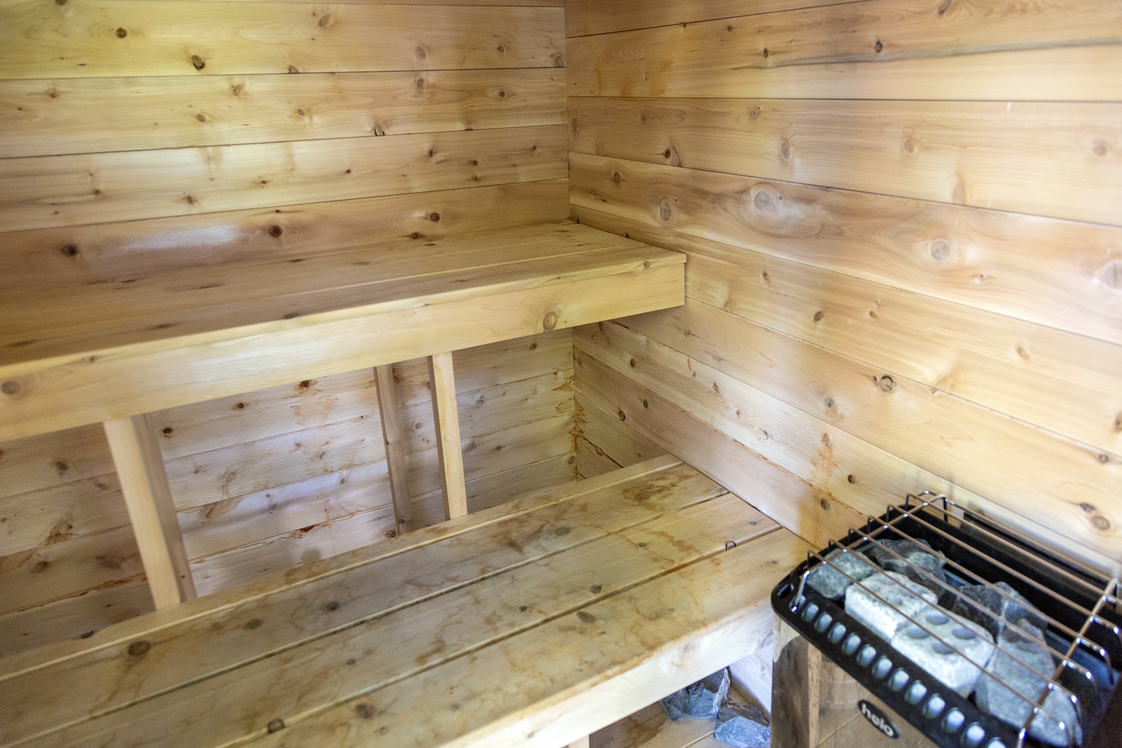 Step into your private sauna, where fragrant cedarwood and gentle heat melt away your worries. Unwind on the tiered benches and let the warmth surround you.