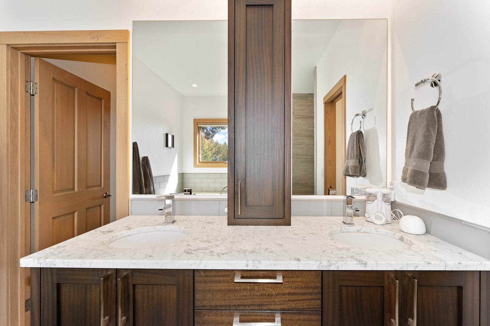 Refresh in your own serene spa-like bathroom with dual vanities, marble countertops, and elegant wood cabinetry that bring warmth to every morning.