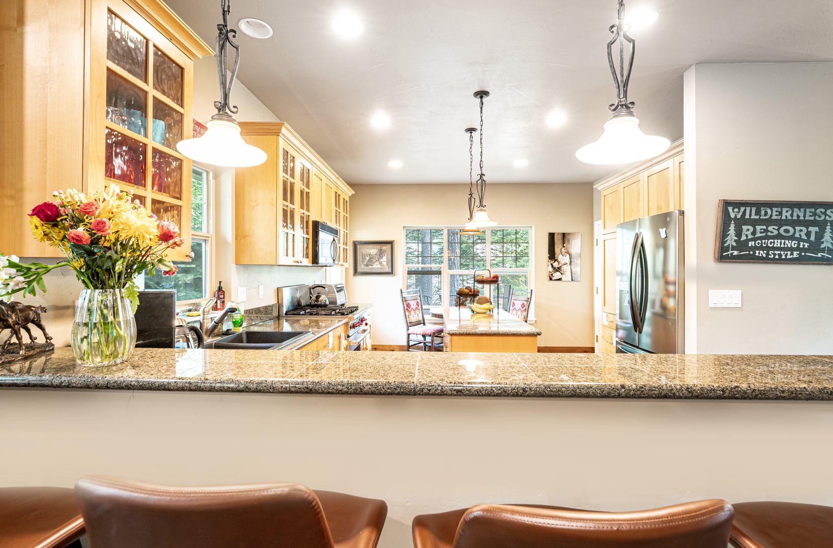 Your gourmet kitchen welcomes you with warm wood cabinetry, granite countertops, and pendant lighting—perfect for cooking up vacation memories together.
