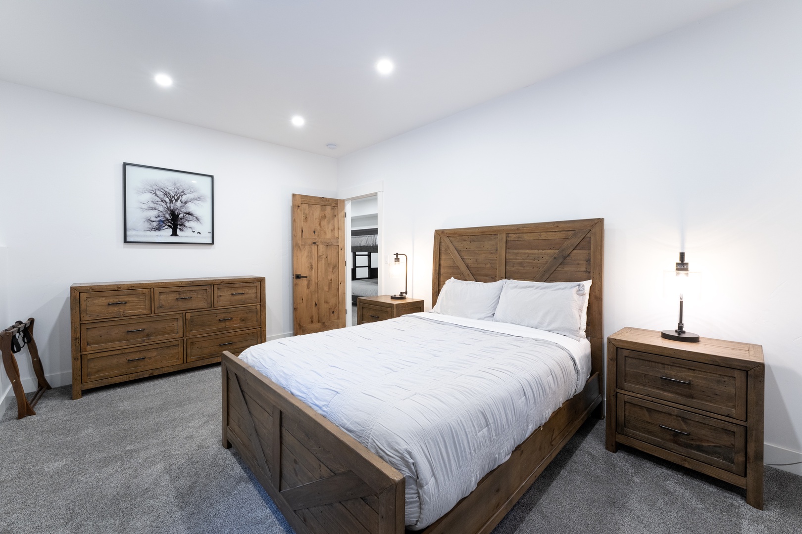 Unwind in your spacious bedroom with handcrafted wooden furniture and crisp linens for a restful retreat.