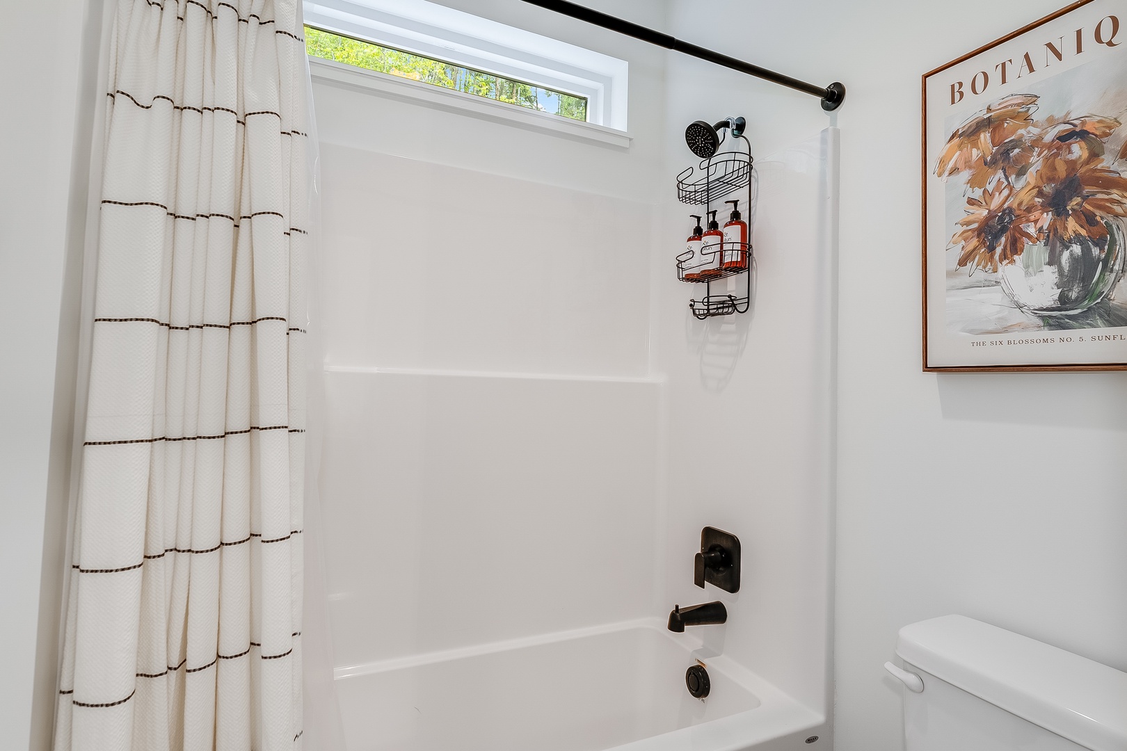 Step into your refreshed bathroom with a full tub-shower combo, soft linens, and natural light filtering in—ideal for unwinding after a day exploring the area.