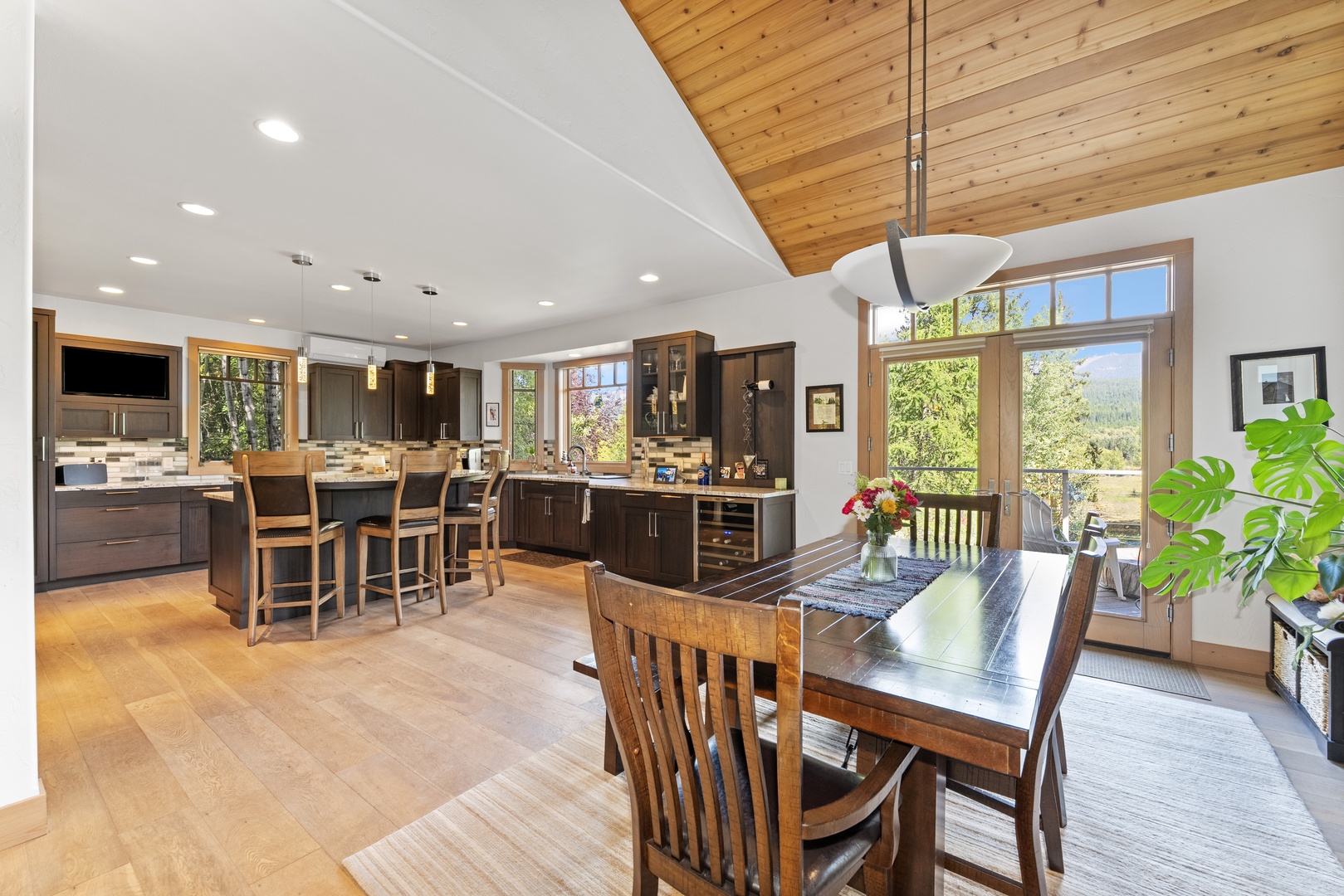 Cook, dine, and unwind together in this expansive open-plan kitchen and dining area, where stunning mountain views through towering windows make every meal a retreat.