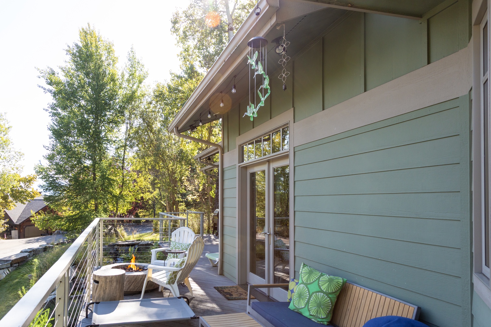 The property sits nestled among tall trees in a peaceful natural setting, with modern architecture complementing the surrounding landscape.
