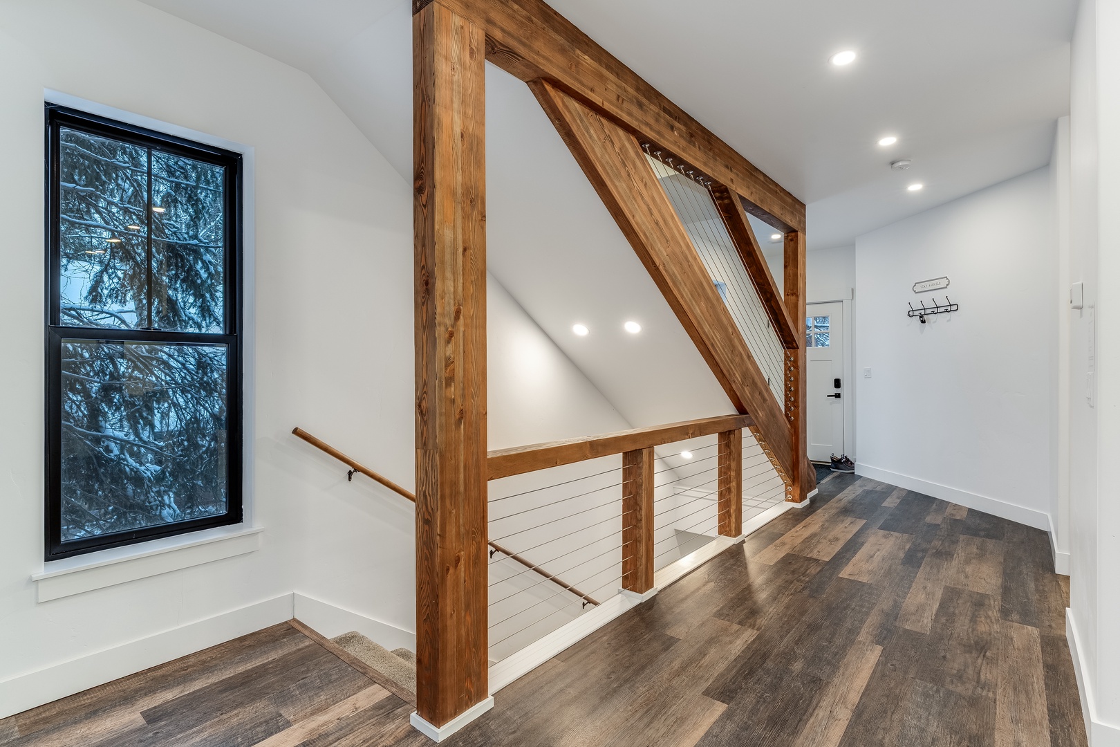Modern mountain retreat with stunning wood beam architecture and sleek cable railings creating your perfect alpine sanctuary.