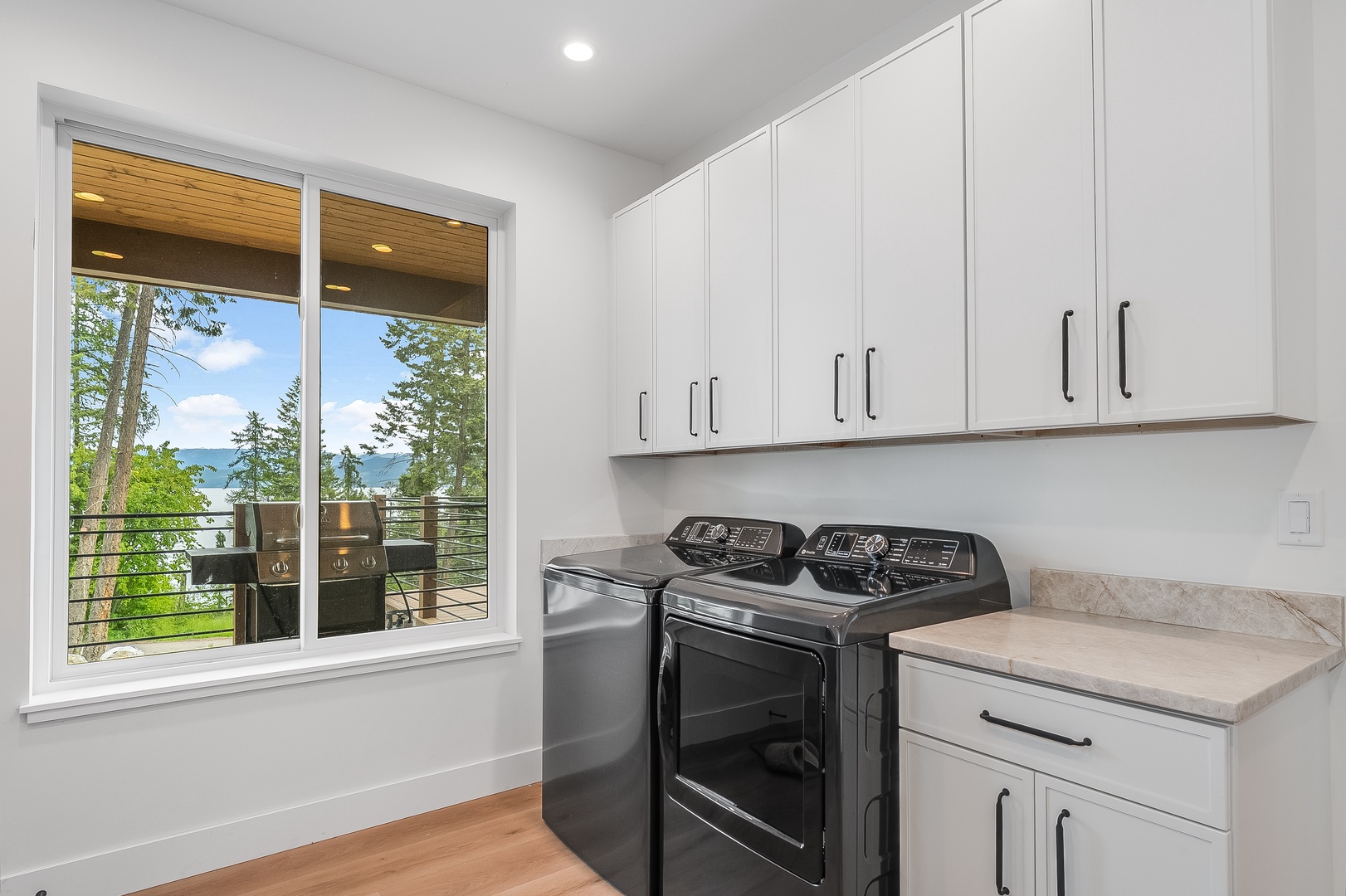 Your laundry room features modern appliances and abundant storage, with natural light and scenic views making chores feel less like work and more like a peaceful retreat.