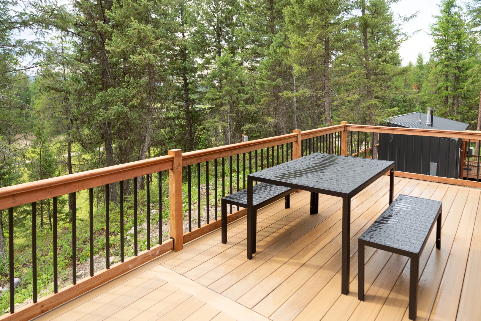 Step onto your private deck and breathe in the forest air while enjoying meals at the outdoor table surrounded by towering trees.