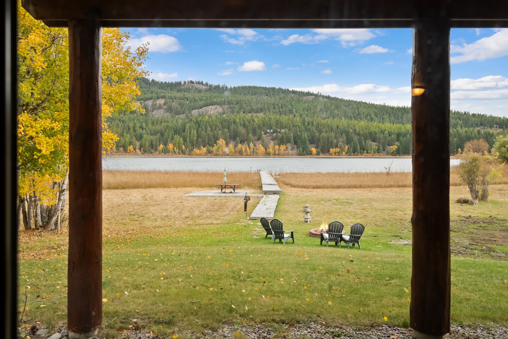 Your private lakefront paradise awaits - step onto the deck to breathtaking mountain views and peaceful waters.