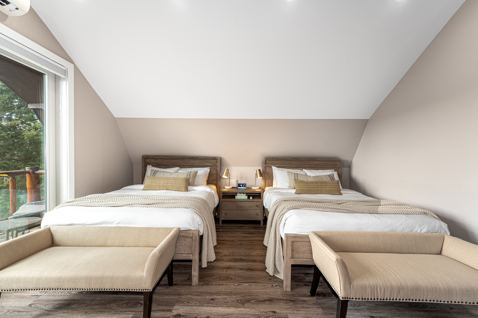 Relax in your private attic bedroom with two cozy beds, warm wood accents, soft natural light, and peaceful views—your perfect retreat after a day of adventure.