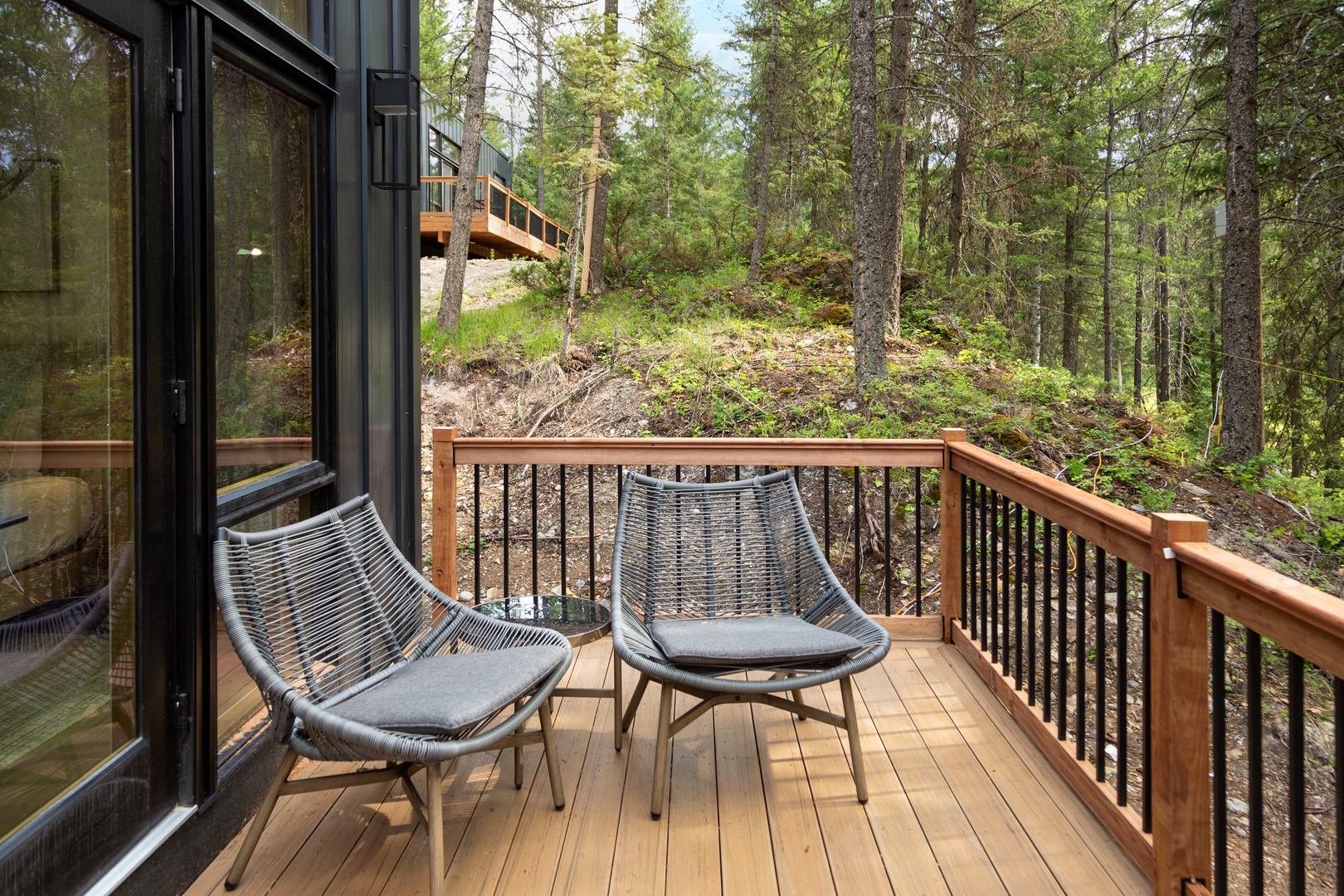 Step onto your private deck and sink into modern lounge chairs, surrounded by towering pines and the peaceful sounds of nature all around you.