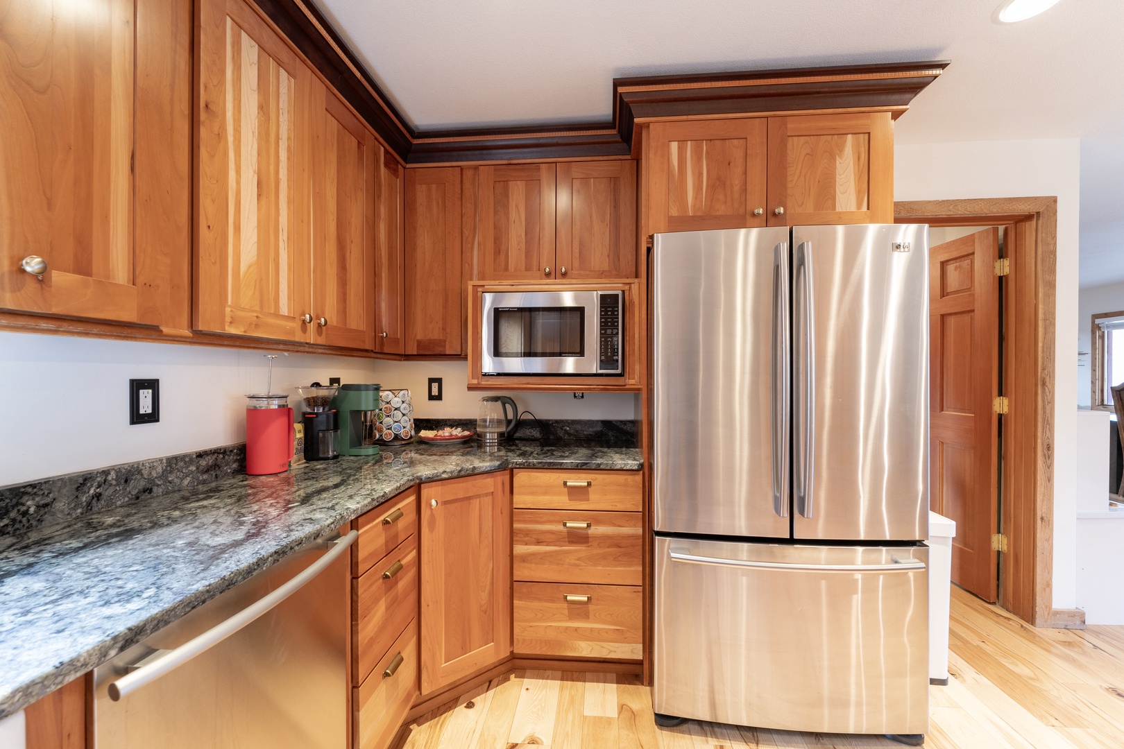 Your gourmet kitchen awaits with rich wood cabinetry, granite countertops, and stainless steel appliances—perfect for creating memorable meals during your stay.