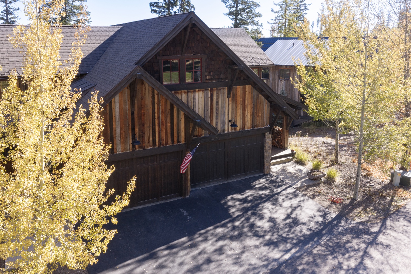 A stunning mountain retreat surrounded by golden aspens, offering a peaceful escape nestled in nature's beauty with convenient garage parking and rustic charm.