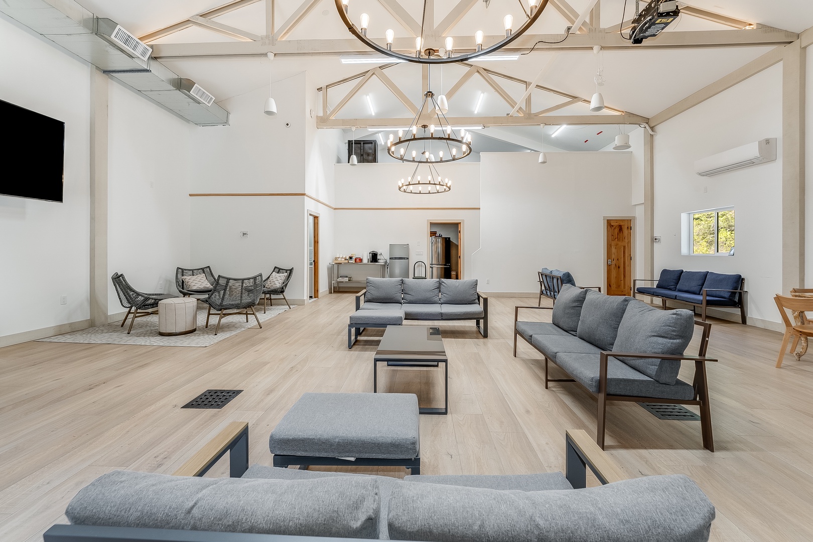 This airy communal lounge features soaring timber-beamed ceilings and abundant natural light, offering cozy seating areas where you can unwind, connect with fellow travelers, or enjoy movie nights on the big screen.