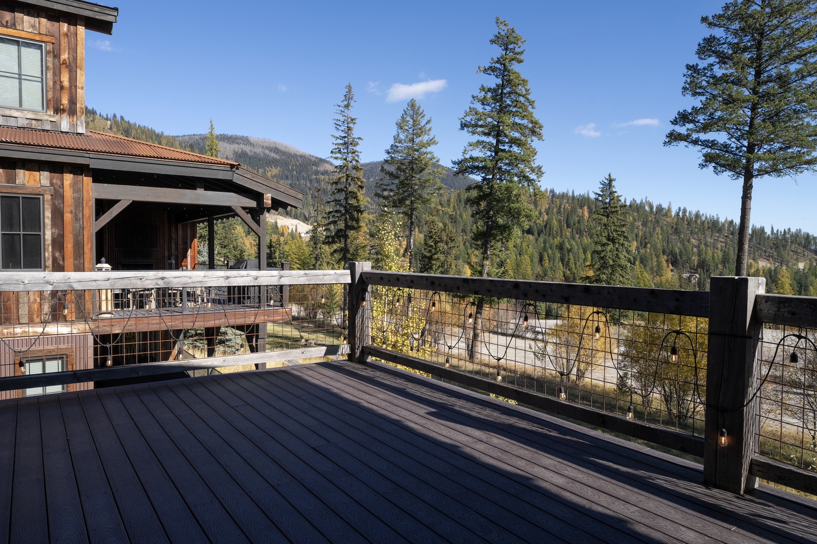 Step onto your private deck and breathe in the mountain air. Sweeping forest and mountain vistas stretch before you, framed by towering pines—a serene backdrop for your morning coffee or evening unwind.