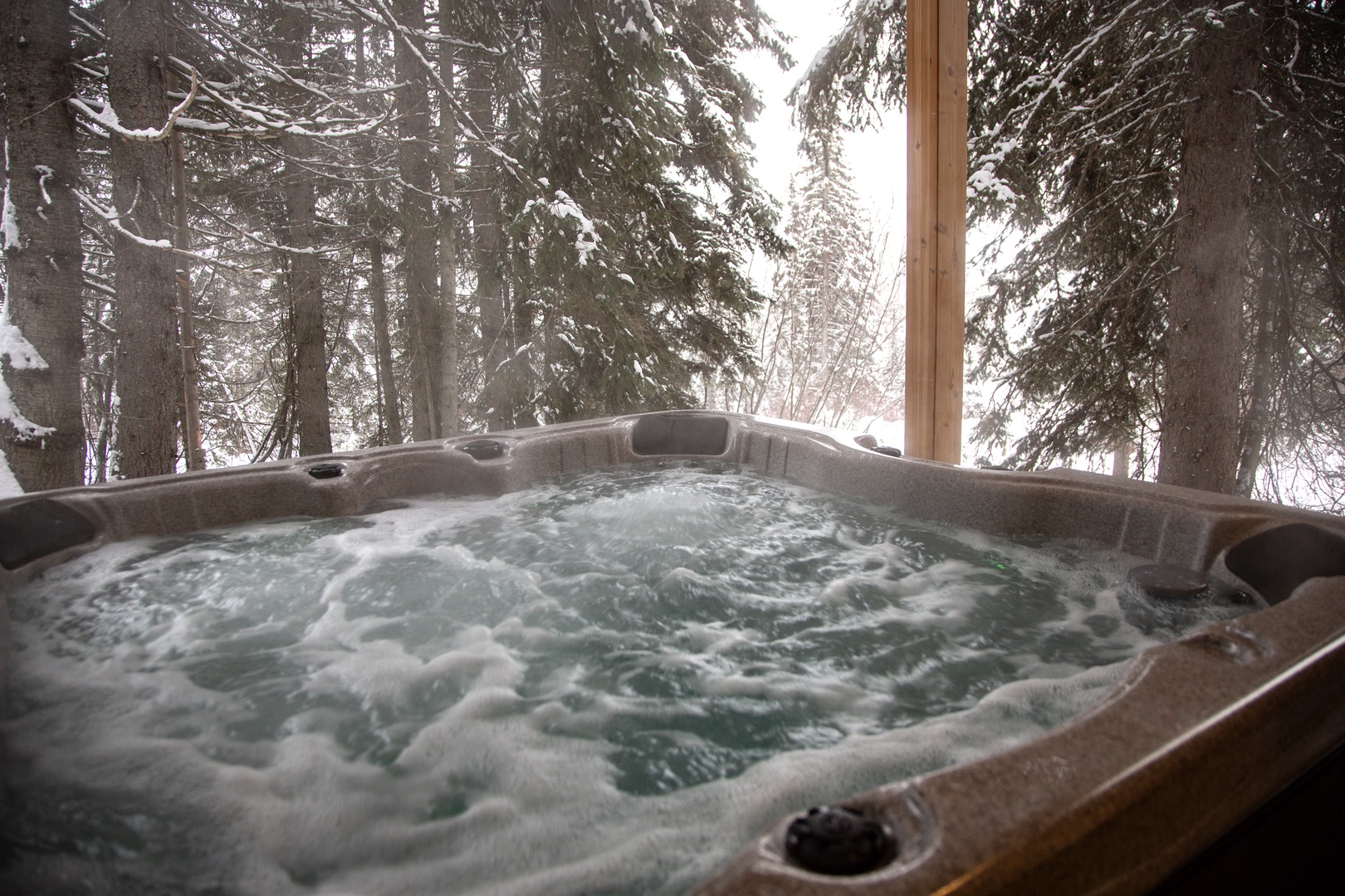 Soak in bubbling warmth while snow-dusted pines create your private winter wonderland backdrop.