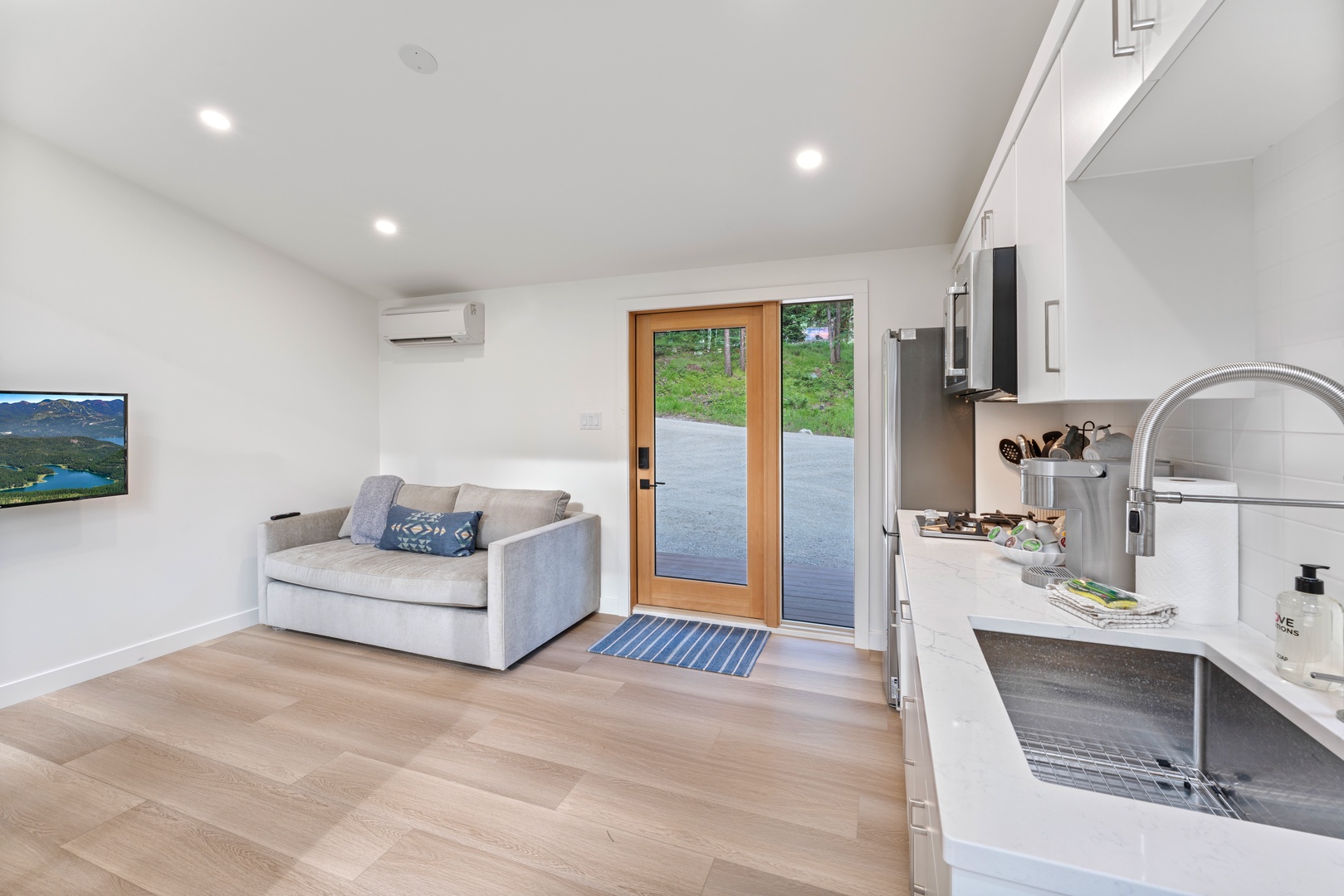 Step into your modern retreat where sleek kitchen flows into cozy living space, perfectly designed for comfort and style.