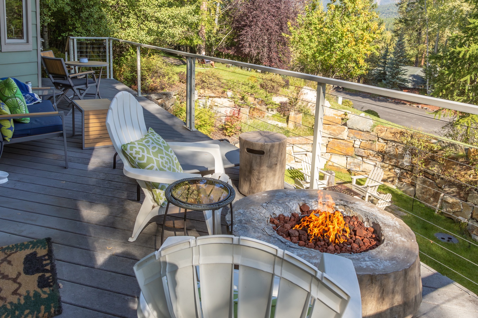 Gather around your private fire pit on the deck, where cozy seating and forested views create the perfect evening retreat.