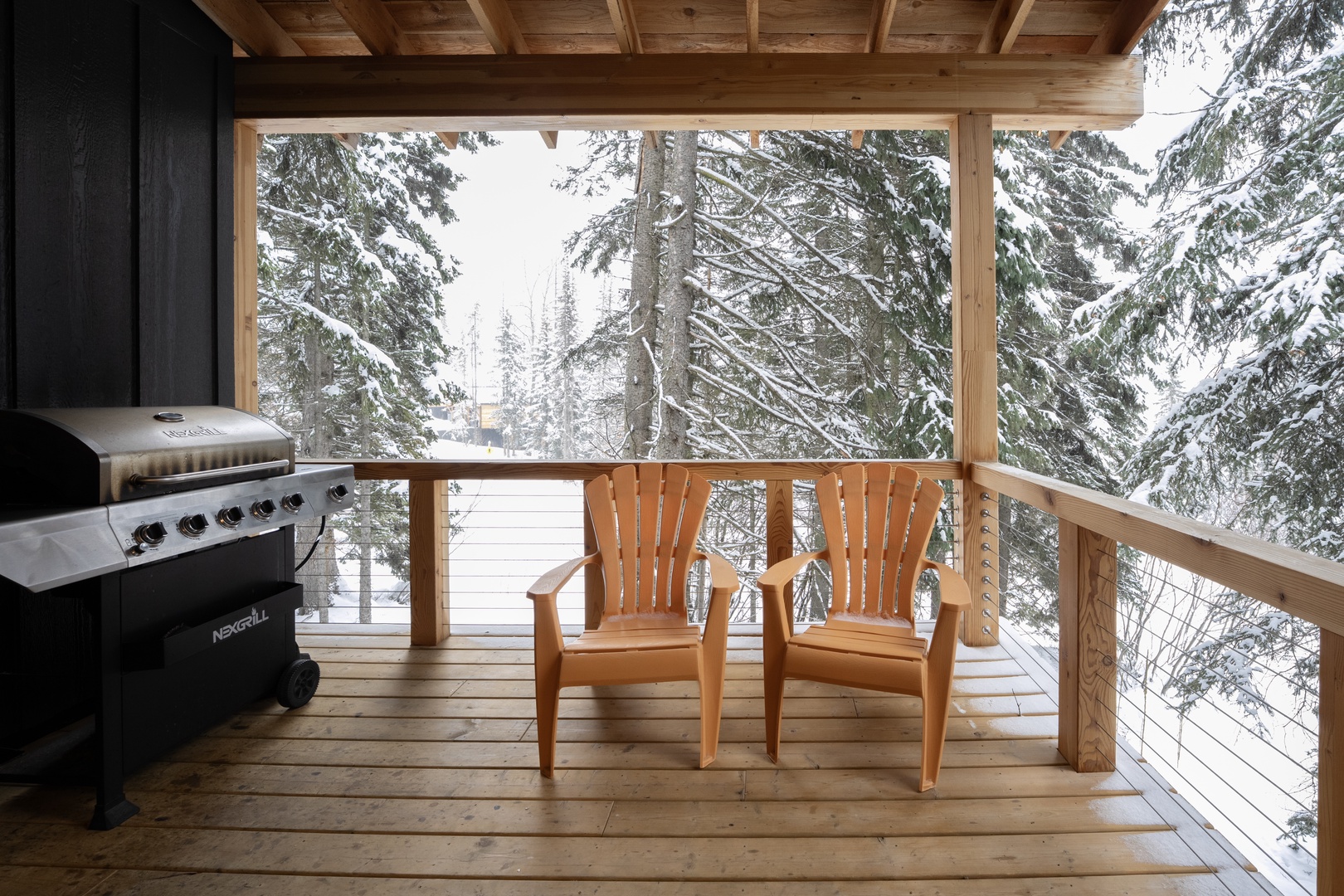 Step onto your private covered deck and breathe in the crisp mountain air while taking in stunning snow-dusted forest views.