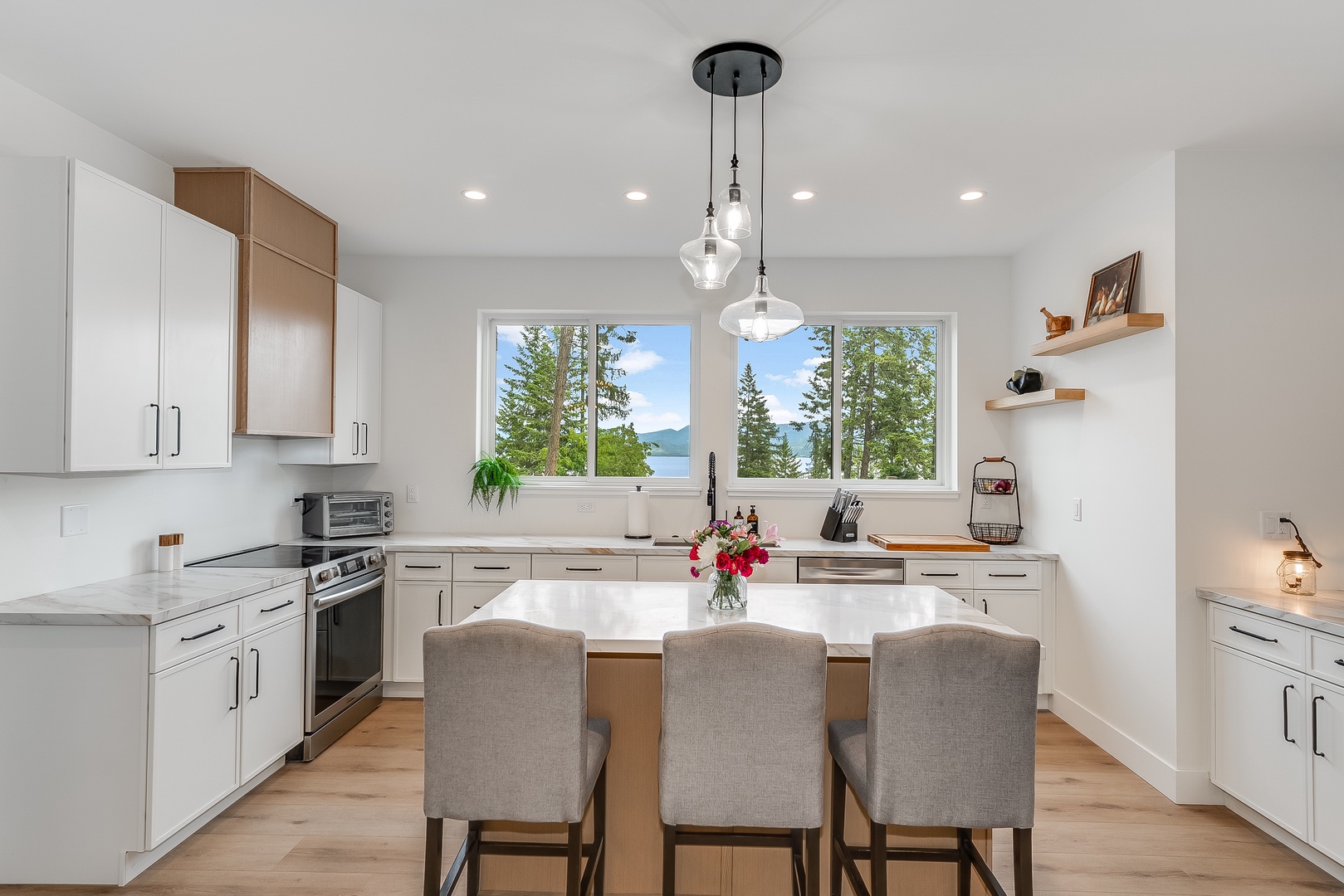 A bright kitchen with lake and mountain views where you'll love preparing meals together. Modern appliances meet natural beauty right from your countertop.