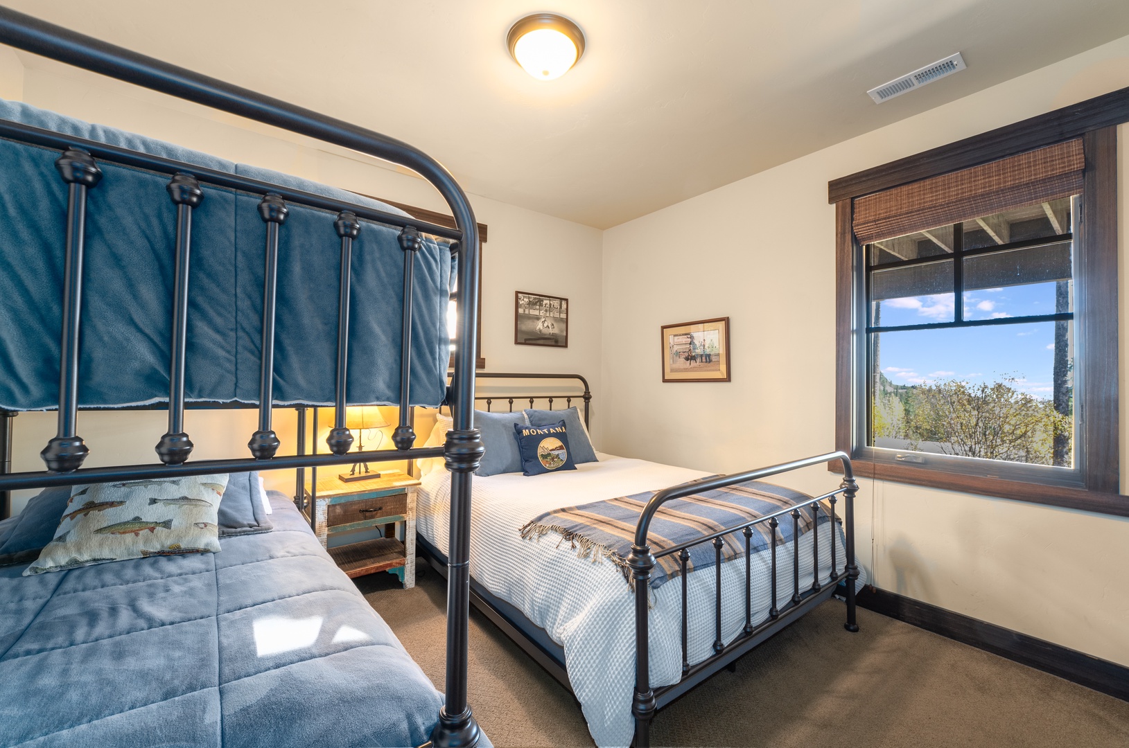 Settle in for the night in this cozy bedroom with bunk beds and cheerful natural light streaming through the window, perfect for families or groups traveling together.