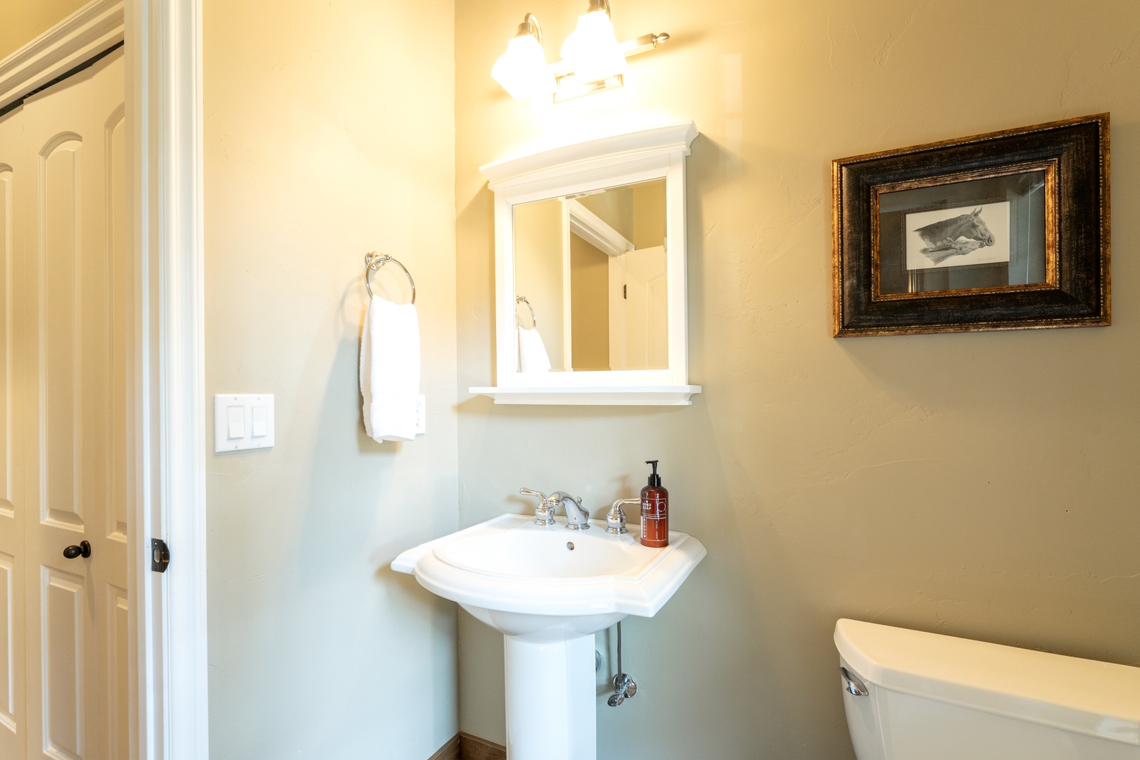 Freshen up in your private bathroom with classic pedestal sink, crisp towels, and thoughtful amenities waiting for you.
