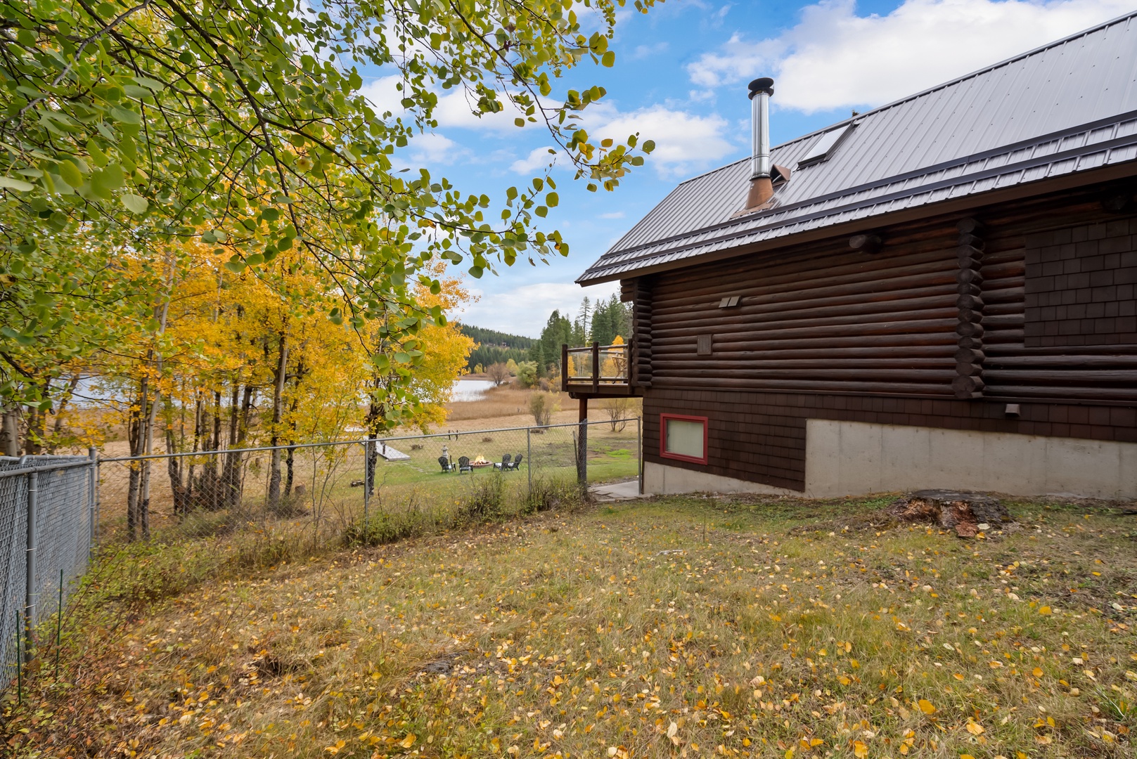 Charming log cabin set amid vibrant autumn foliage and peaceful natural surroundings.