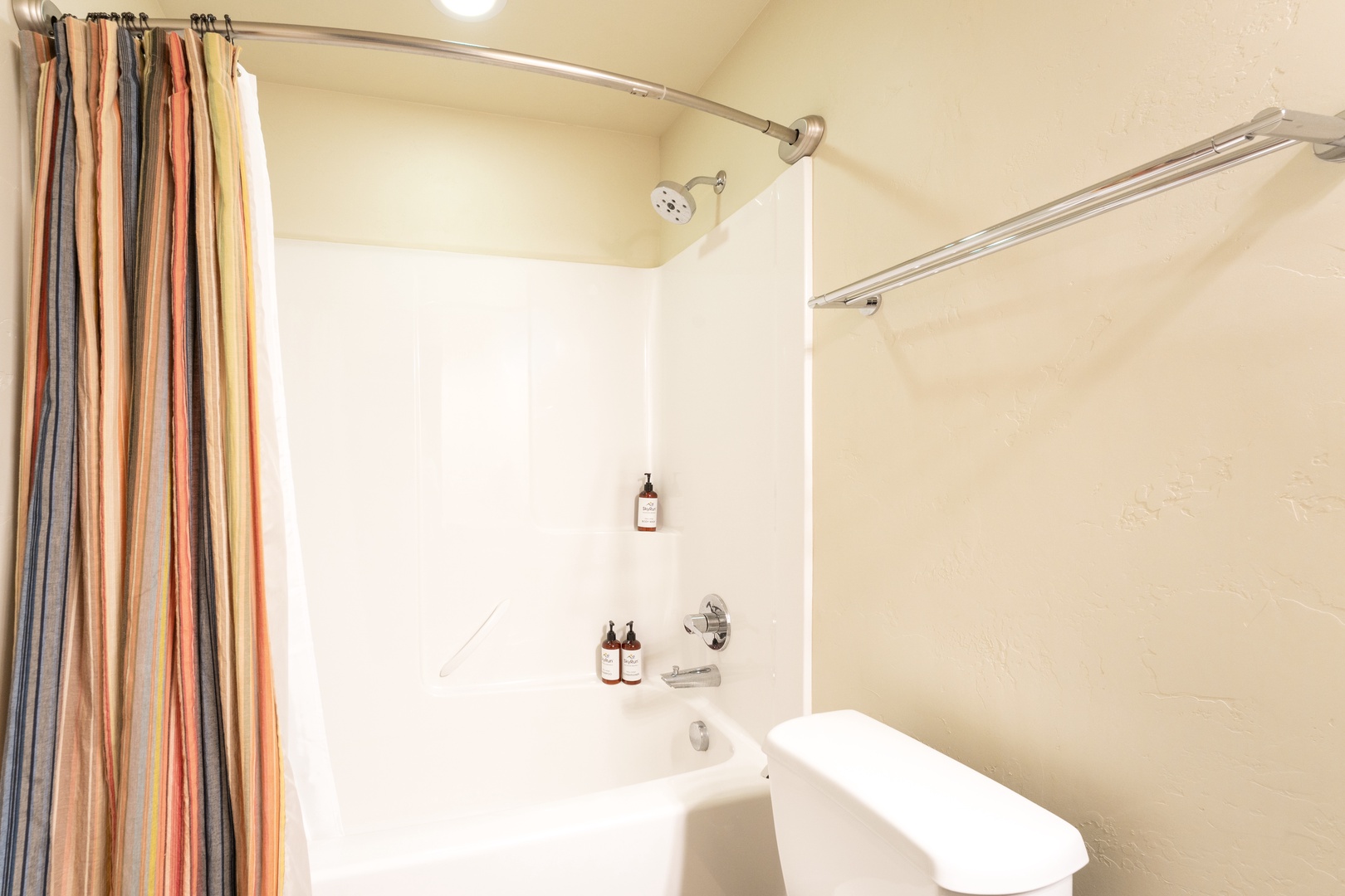 Refresh after your adventures in this clean, modern bathroom with a full tub and shower combo. A cheerful striped curtain adds a splash of color to your private space.
