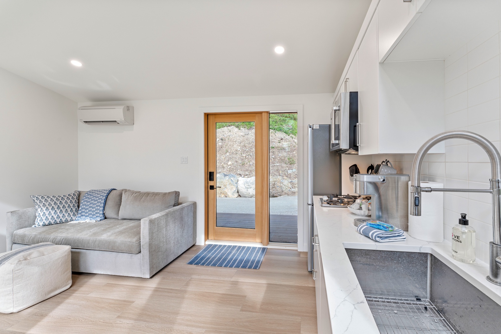 Settle into your modern open-plan sanctuary where sleek kitchen flows into cozy living space, complete with air conditioning comfort.