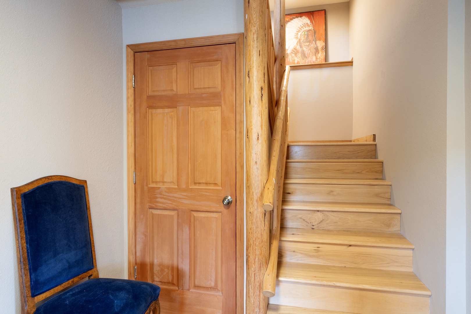 The handcrafted wooden staircase leads you to your private retreat, where rustic charm meets comfort in this thoughtfully designed space.