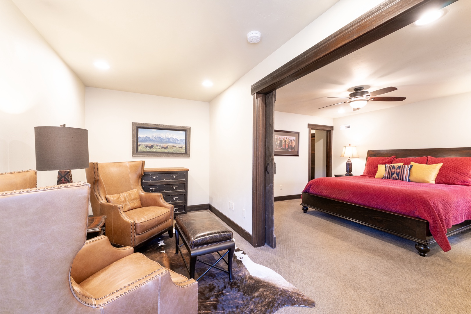Unwind in your spacious suite, where rustic wood beams and plush leather seating create a warm retreat after a day of adventure.