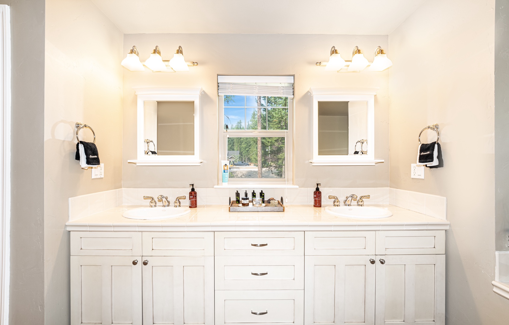 Indulge in your morning routine at this elegant double vanity, where crisp white surfaces and warm lighting create a spa-like atmosphere for starting your day refreshed.