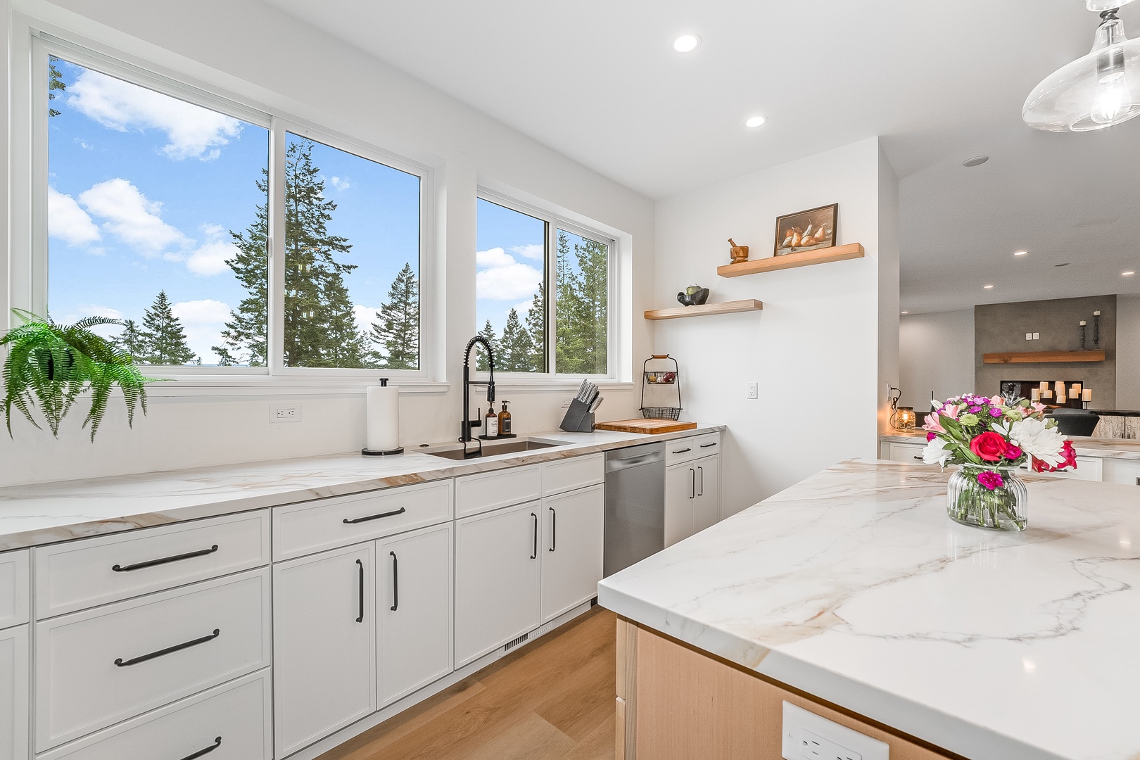 Step into your bright, fully equipped kitchen, where marble counters, modern appliances, and sunlight streaming through expansive windows create the perfect space to cook, gather, and savor every moment.