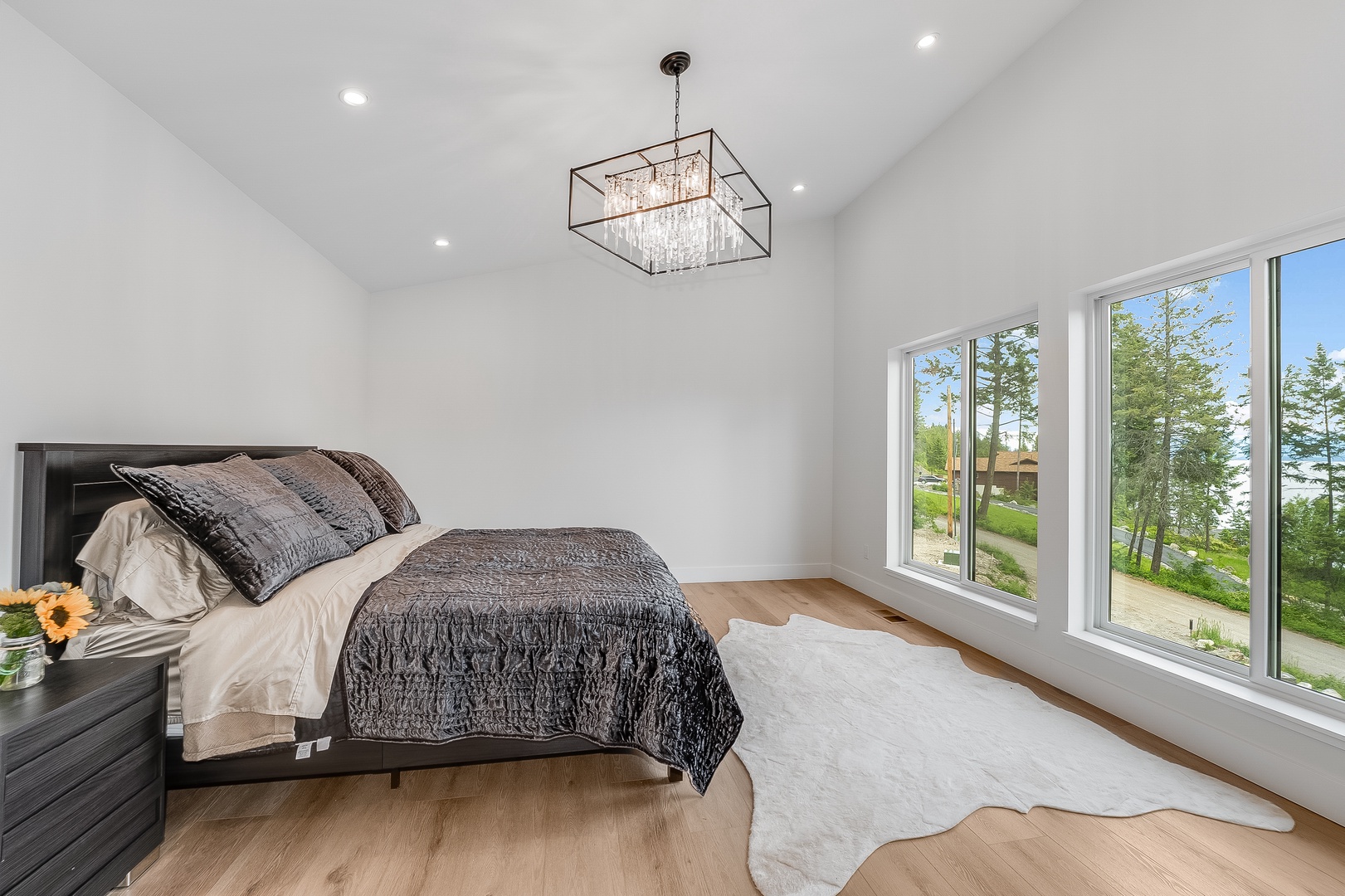 Wake up to stunning waterfront views and natural light in your serene bedroom retreat. Vaulted ceilings create an airy, open feel while elegant details help you unwind in style.
