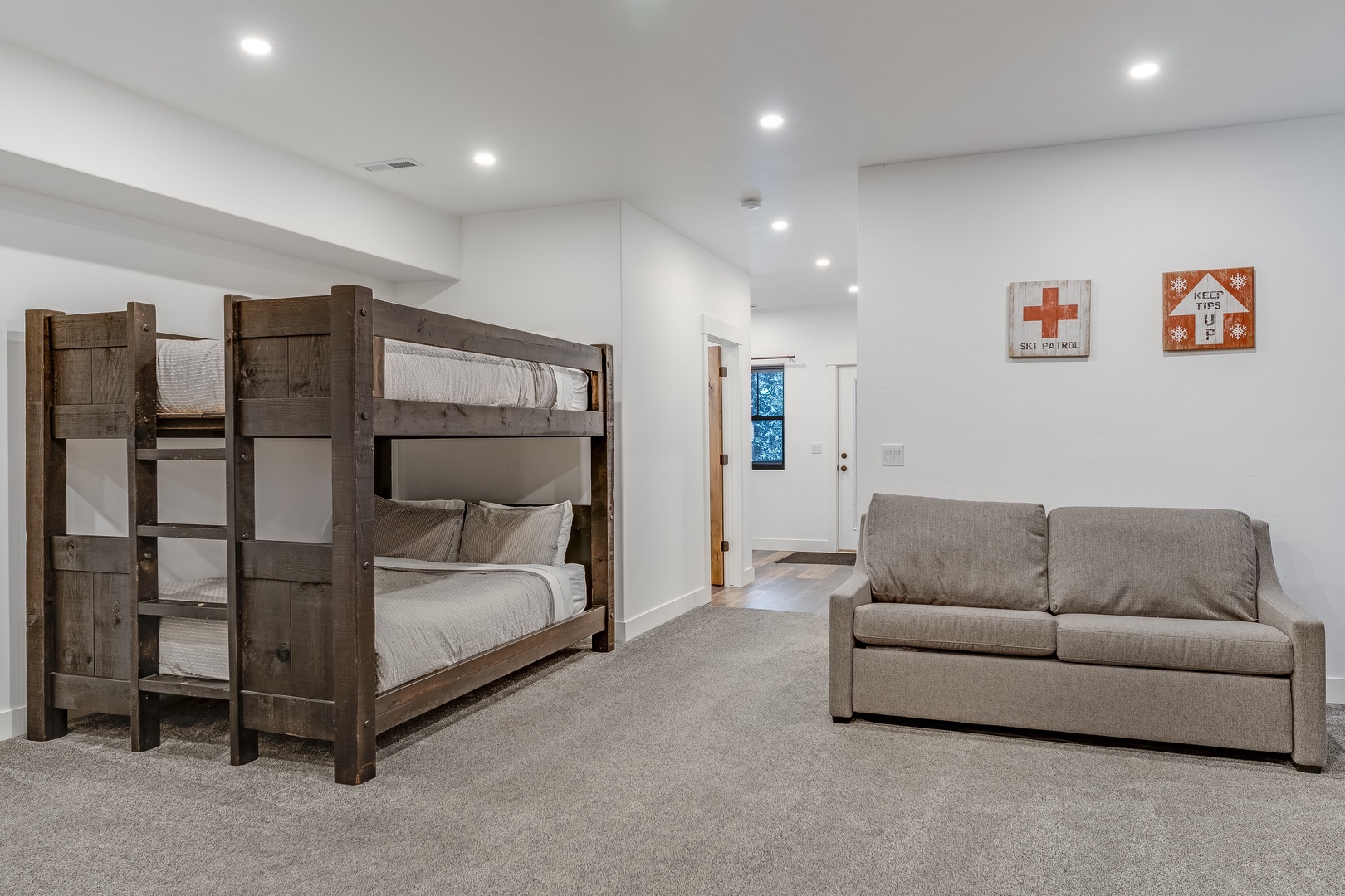 Your family room features rustic bunk beds and a comfy sofa for extra sleeping and relaxation space.