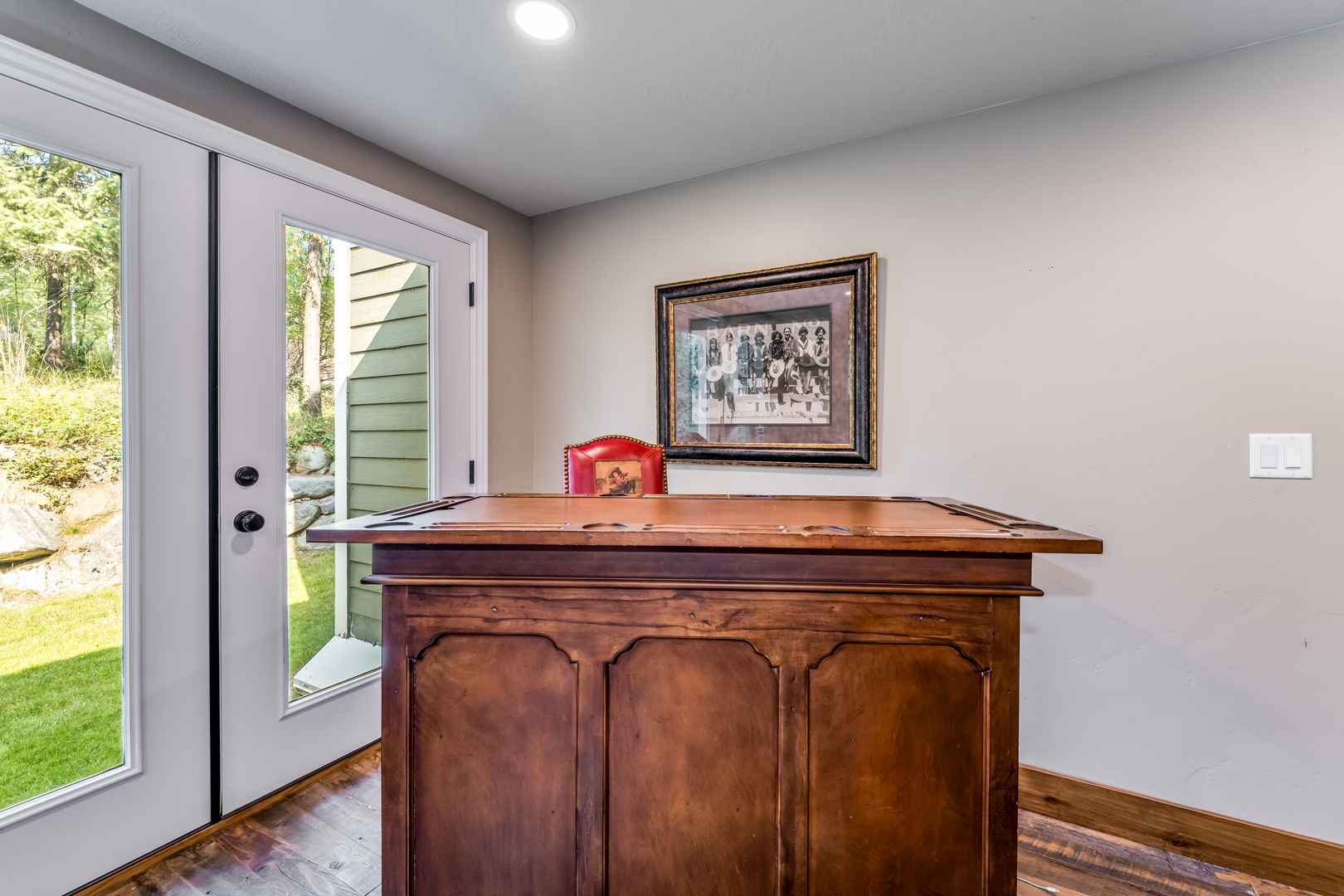 Step into your private retreat with a charming entry area that blends character and comfort. The bright doorway welcomes you to lush garden views beyond.