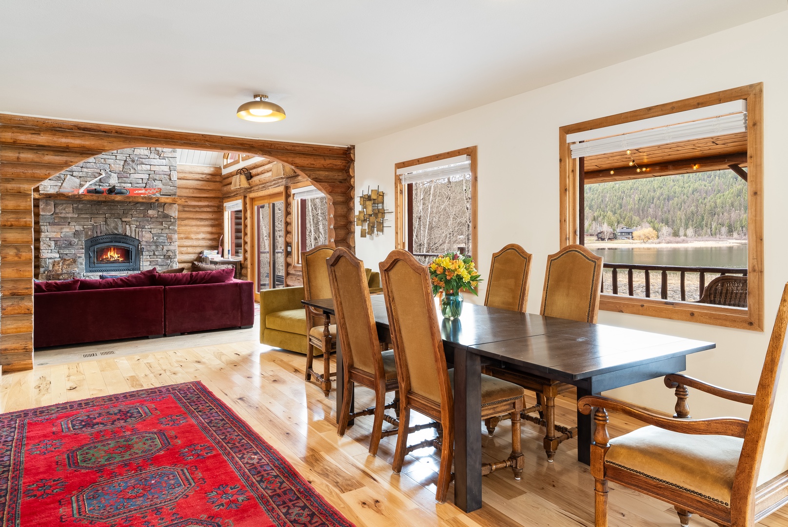 Share memorable meals at your dining table while enjoying mountain lake views and the warmth of the crackling stone fireplace nearby.