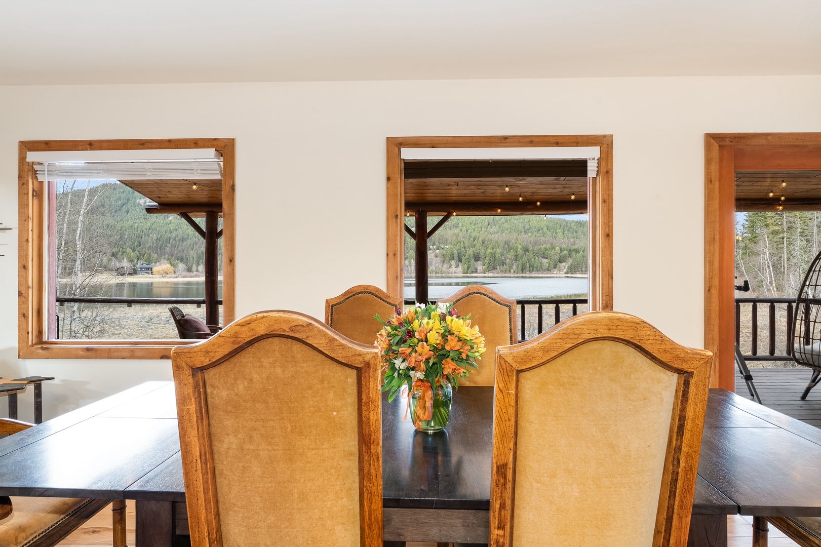 Your dining space opens to stunning lake and mountain views through oversized windows, creating the perfect backdrop for memorable meals together.
