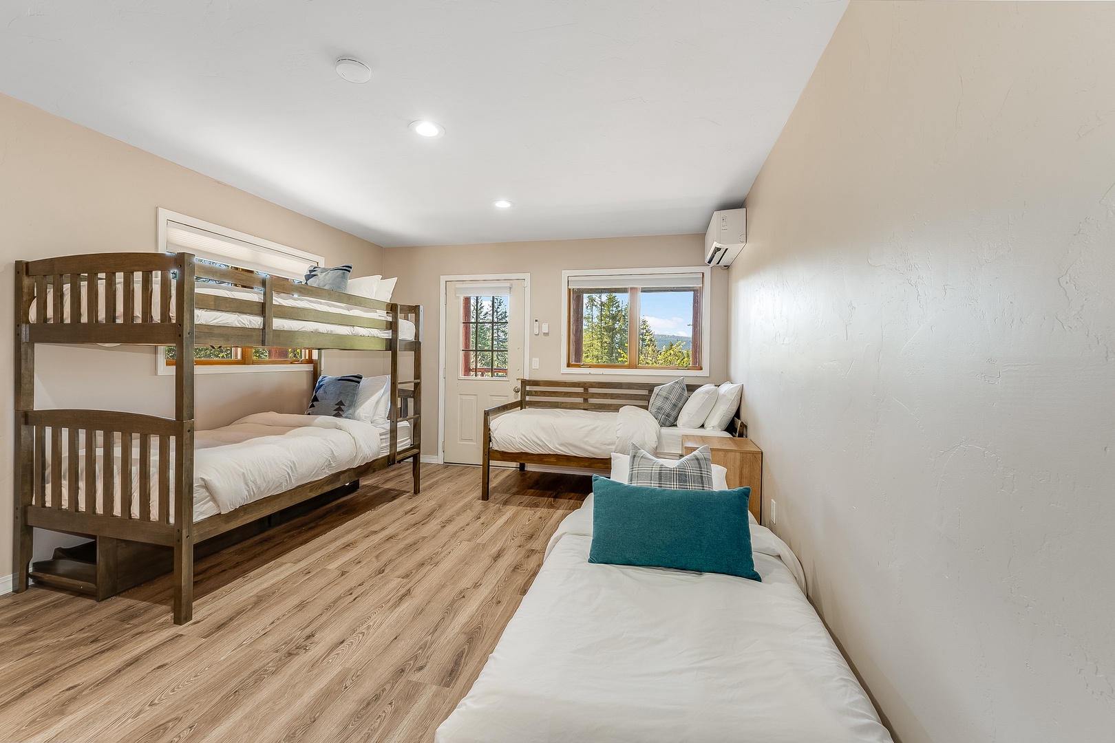Gather everyone in this spacious room where three comfy beds and a bunk bed invite your group to unwind together after mountain adventures. Natural light and peaceful views complete your retreat.