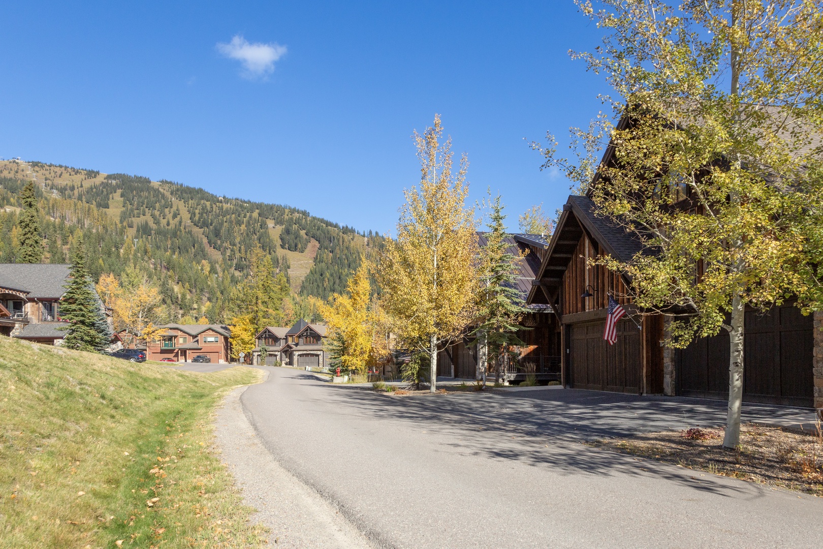 A quiet mountain neighborhood with charming cabins nestled among golden aspens, offering a peaceful retreat surrounded by natural beauty.